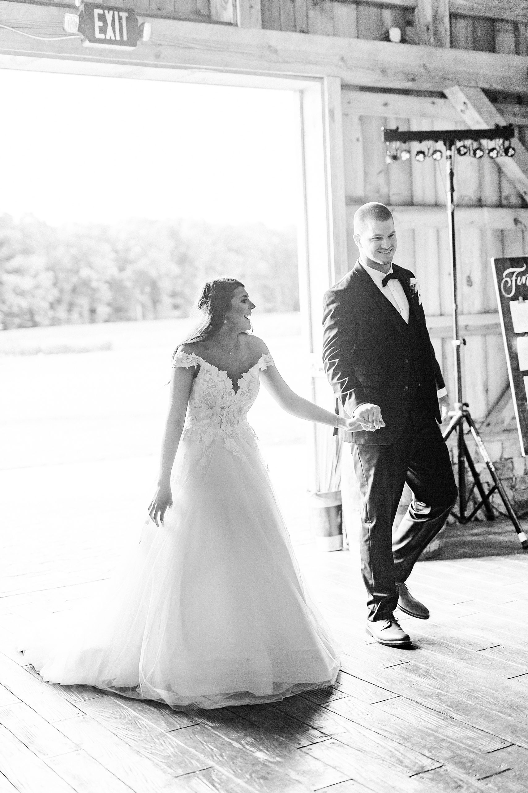 newlyweds enter wedding reception at The Farmstead