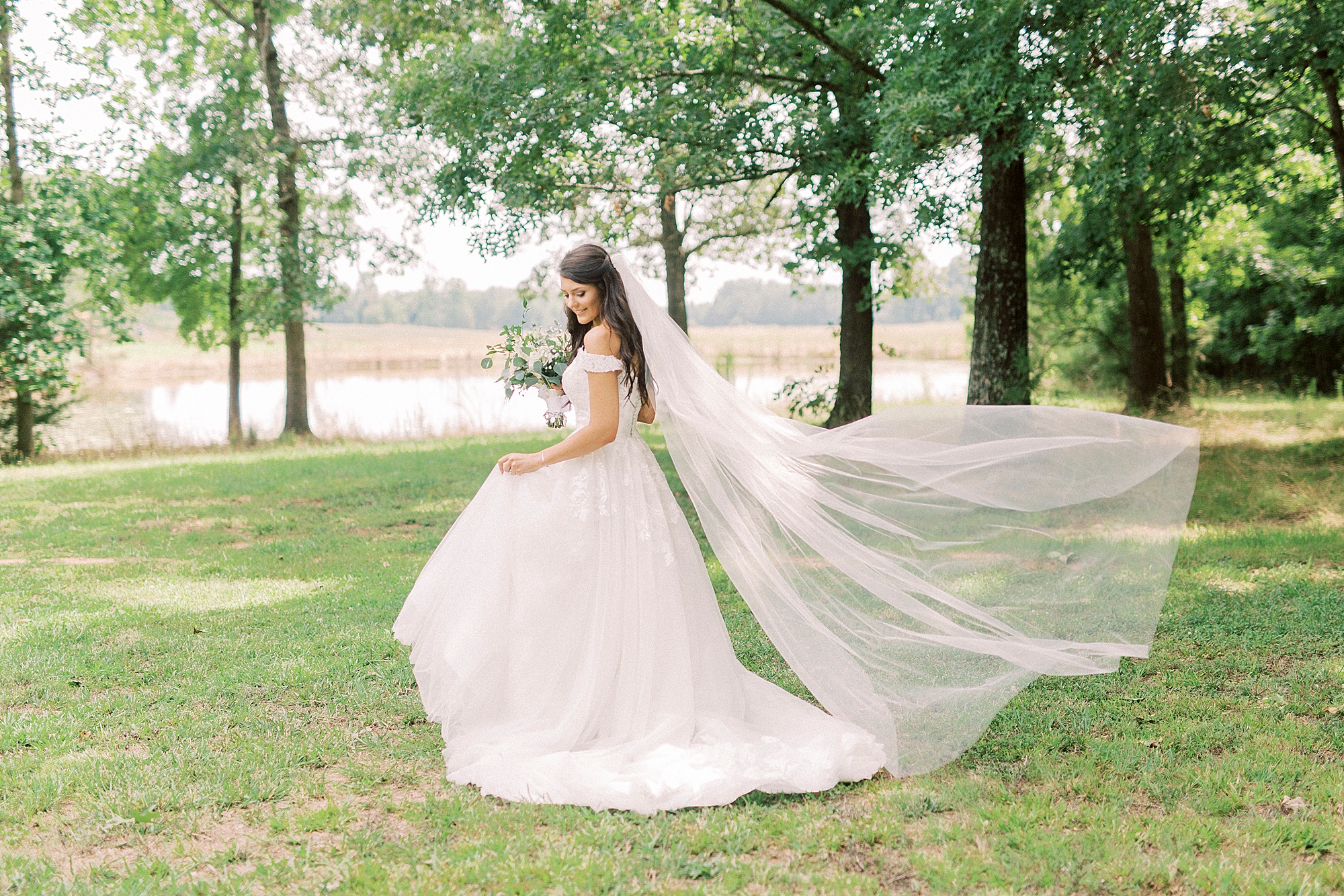 bride twirls in wedding gown with veil floating