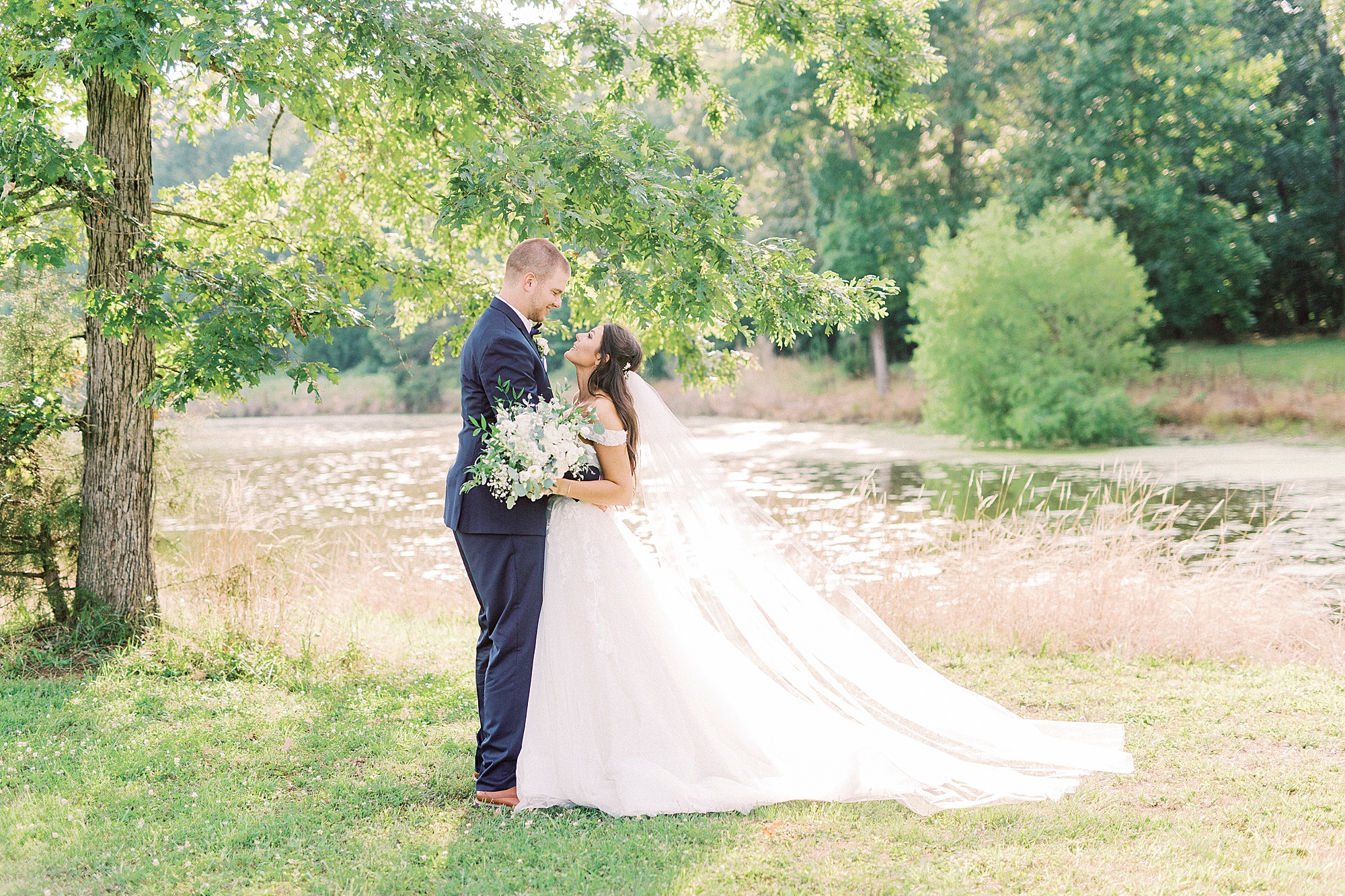 bride looks up at groom during portraits at The Farmstead