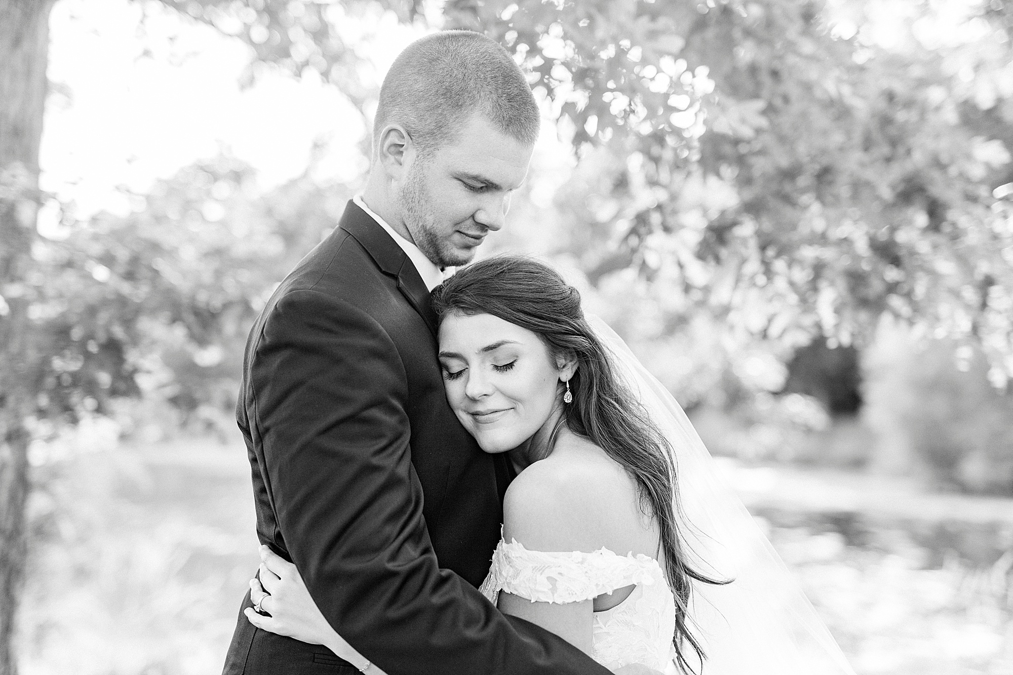 bride hugs groom during The Farmstead wedding portraits