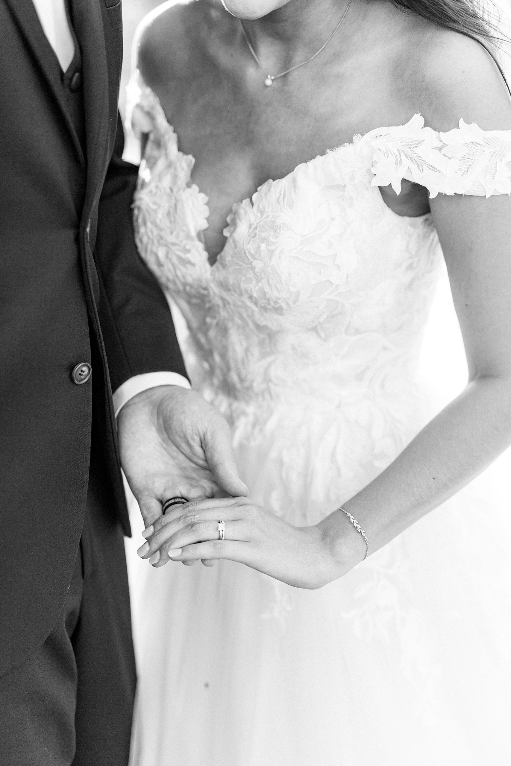 bride and groom hold hands on wedding day