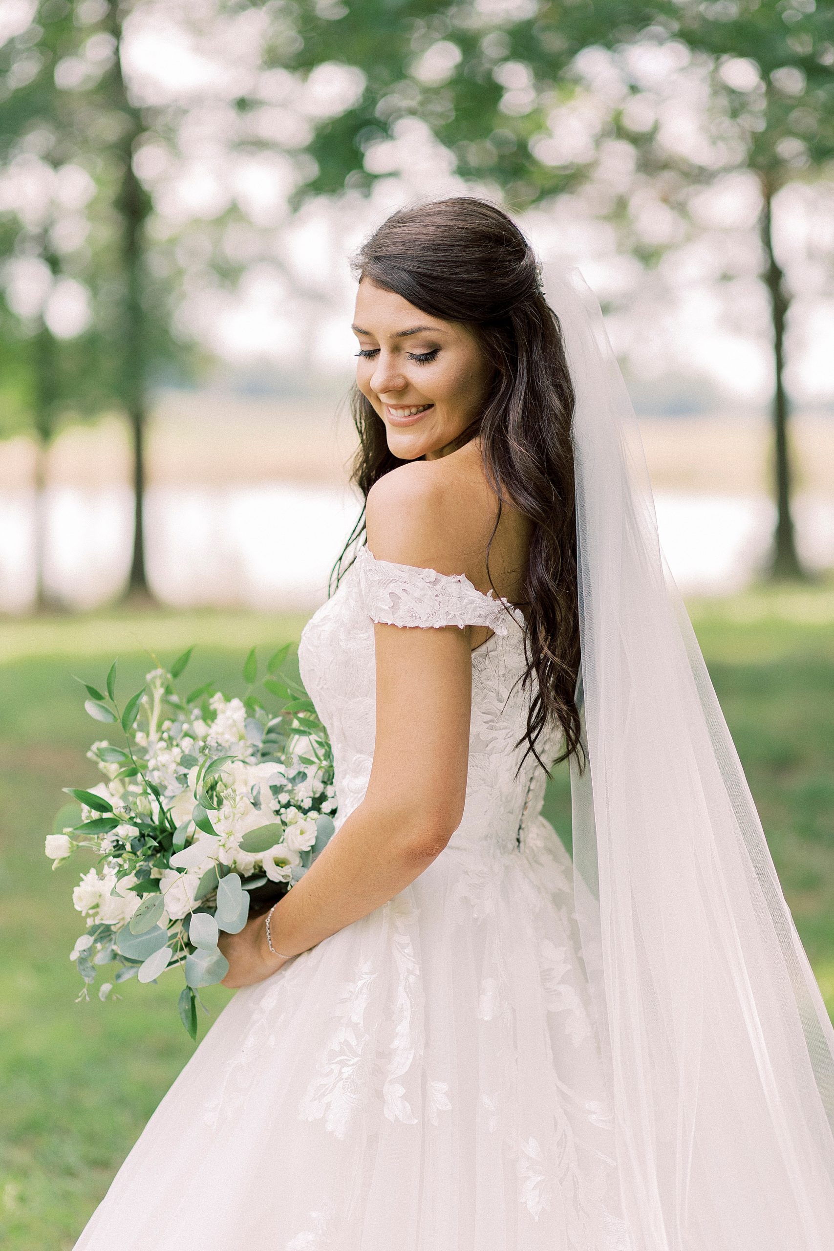bride looks over shoulder during portraits at The Farmstead