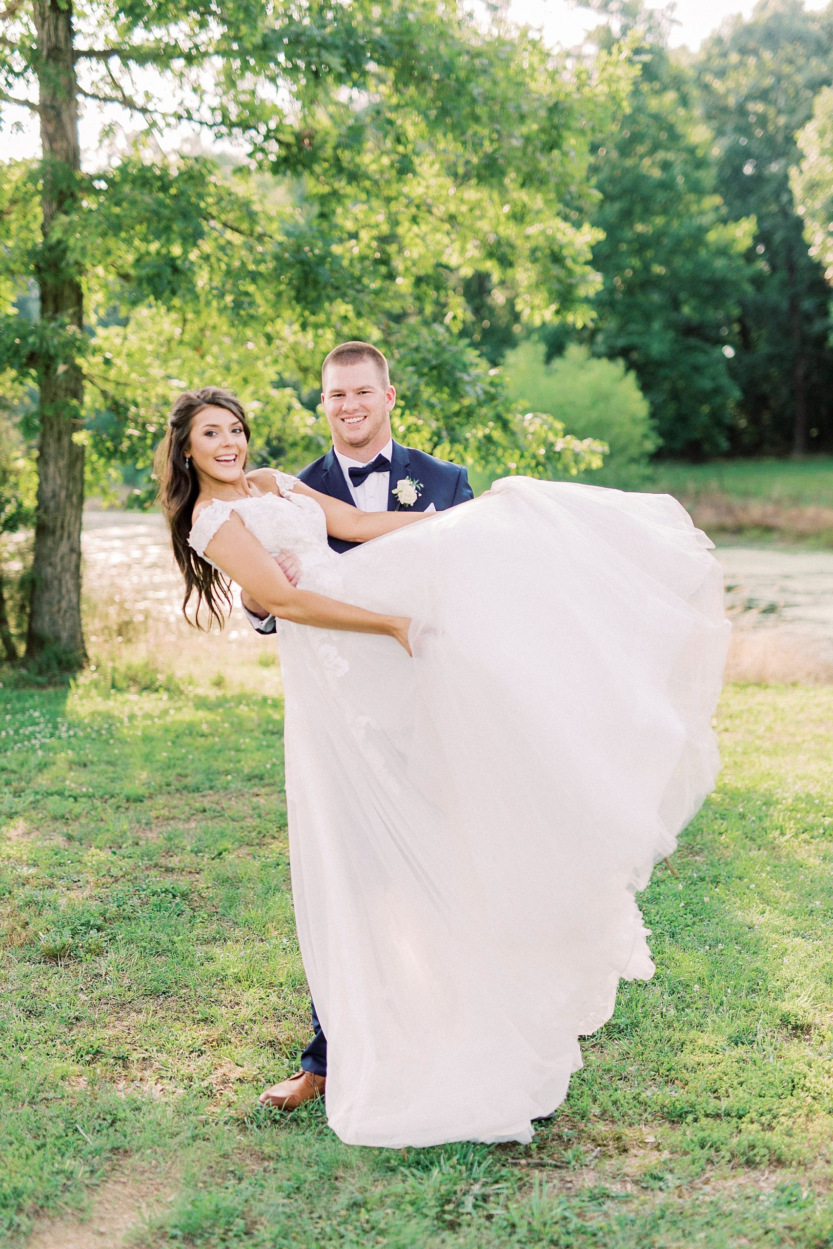 groom lifts bride up during Charlotte NC wedding photos