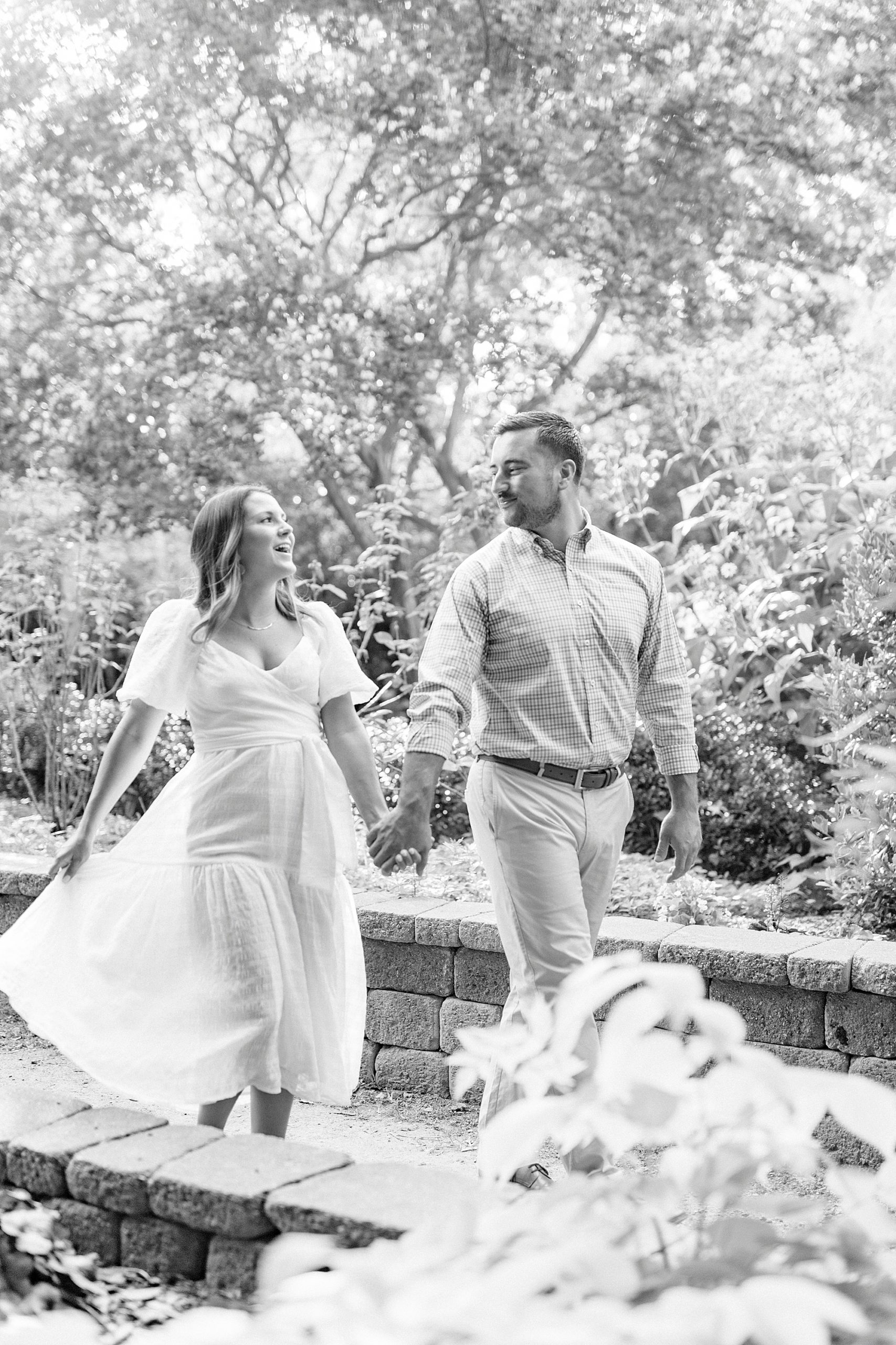 bride and groom walk through McGill Rose Garden