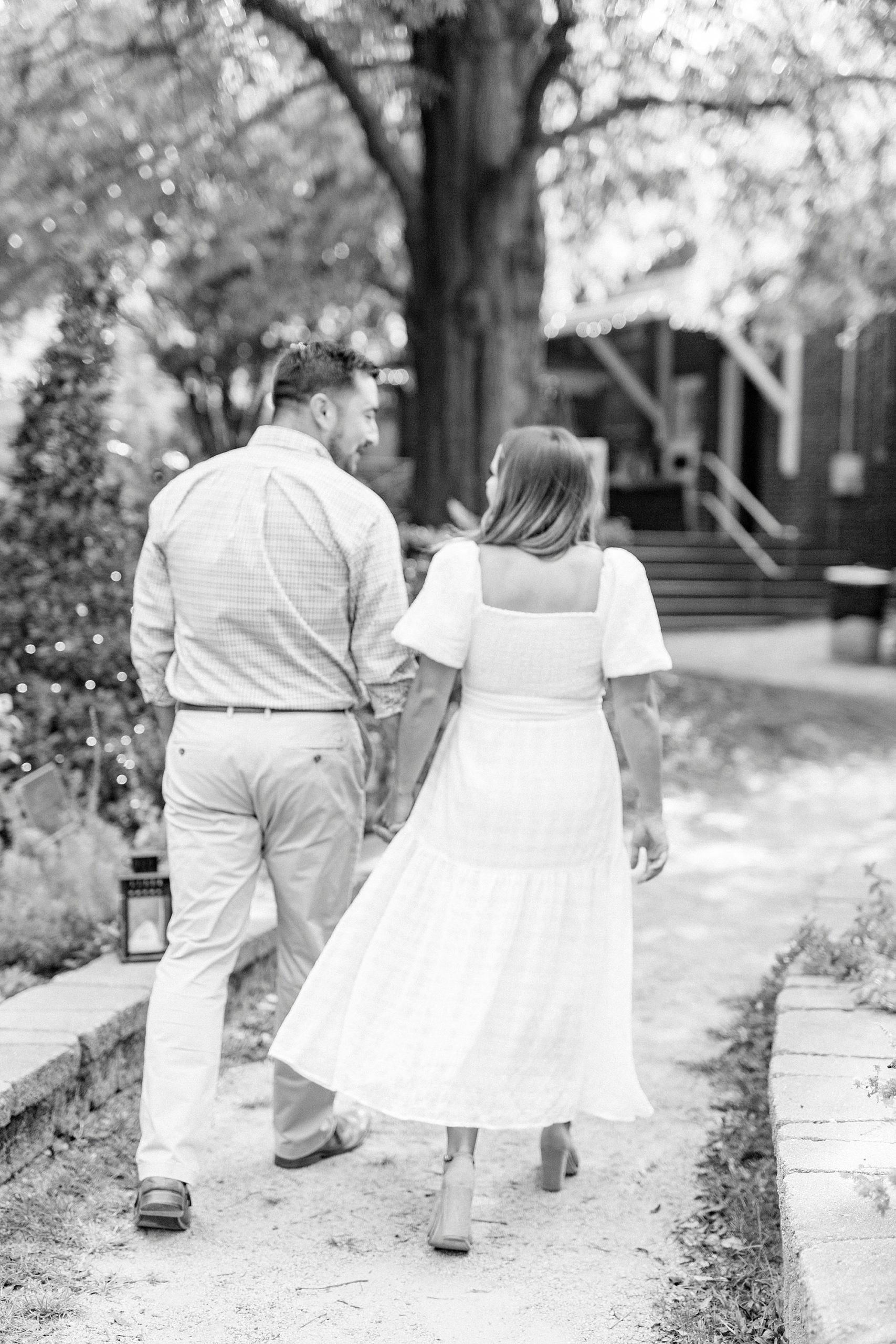 engaged couple walks through McGill Rose Garden