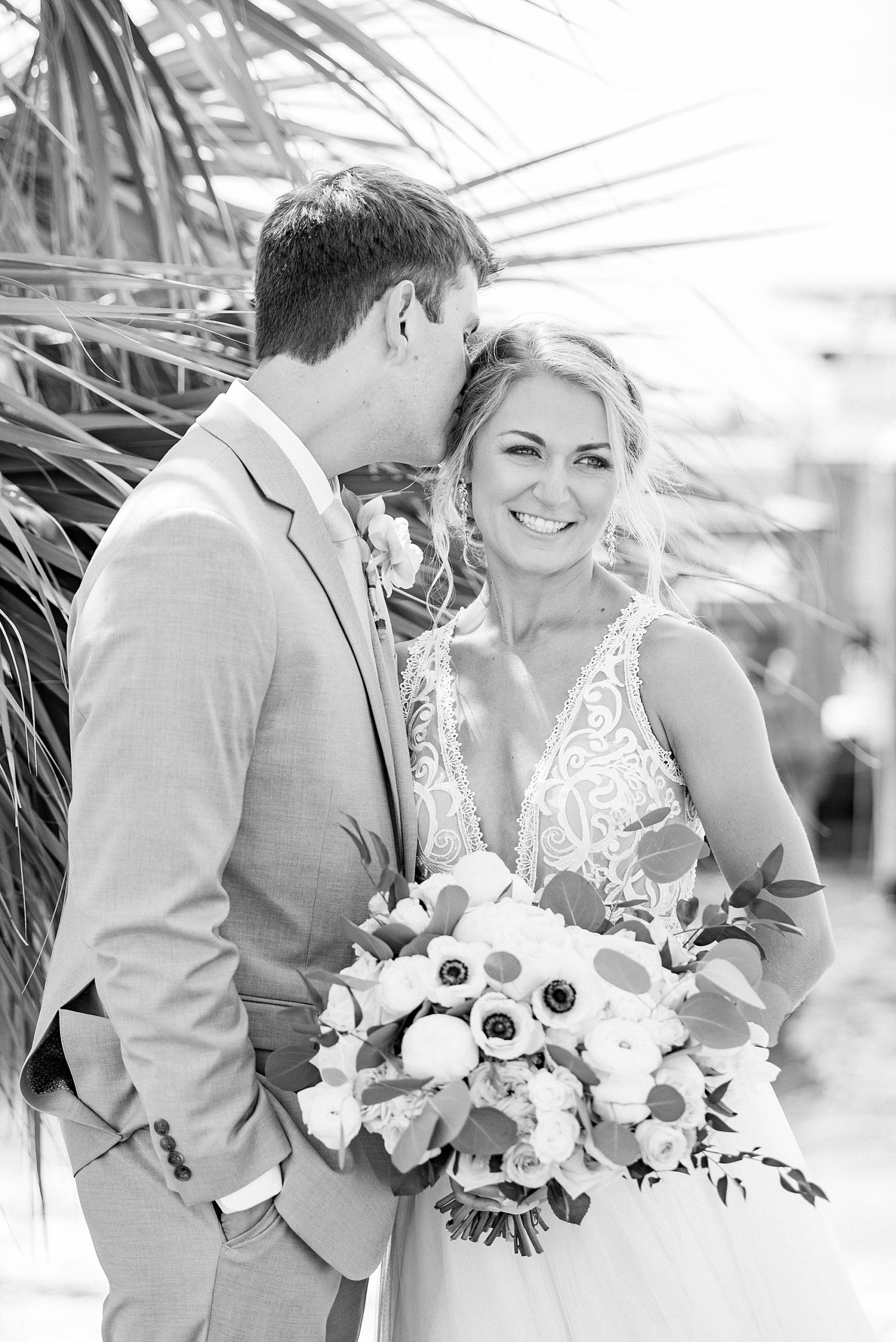 groom kisses bride's forehead during NC wedding photos