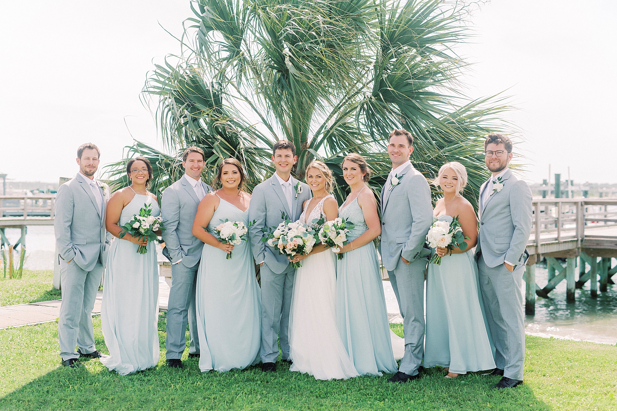 bride and groom pose with wedding party before Oceanic Restaurant wedding