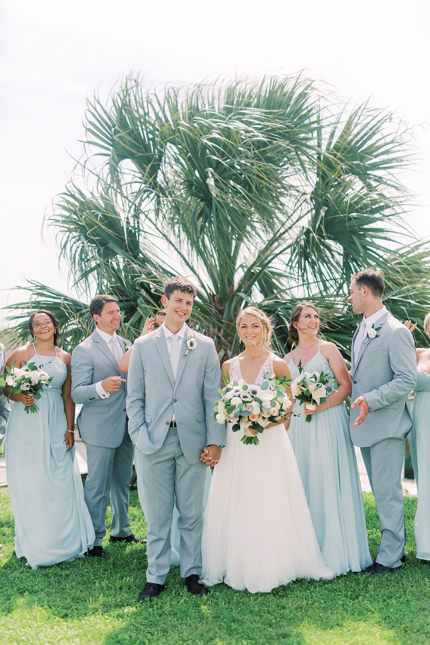 bride and groom walk together with wedding party