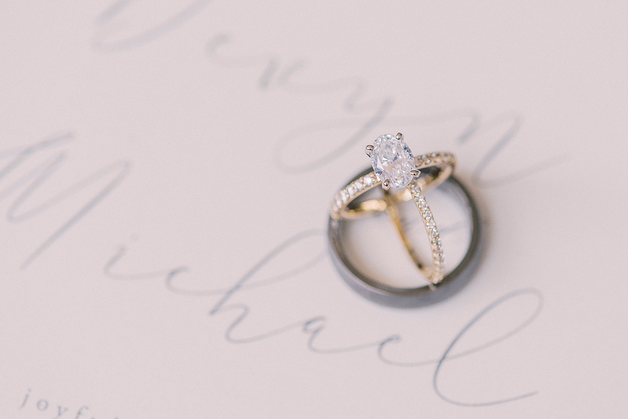 wedding band rests on invitation suite for Oceanic Restaurant wedding