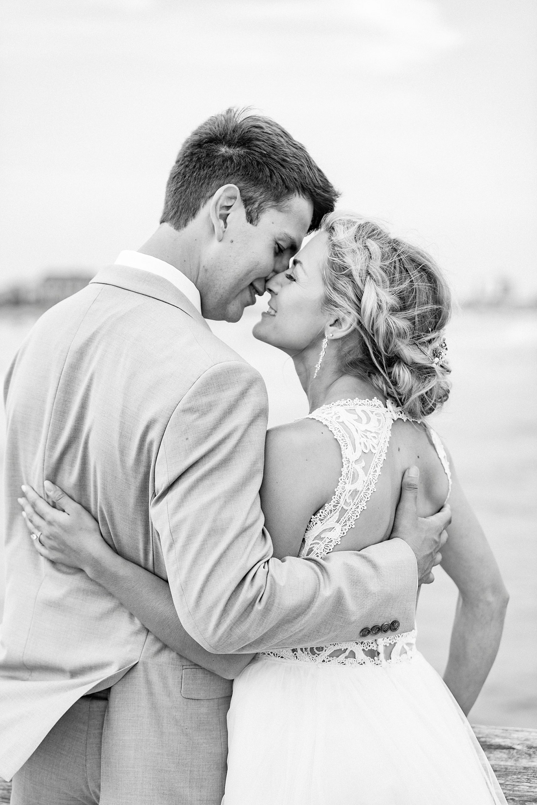 bride and groom lean together to kiss