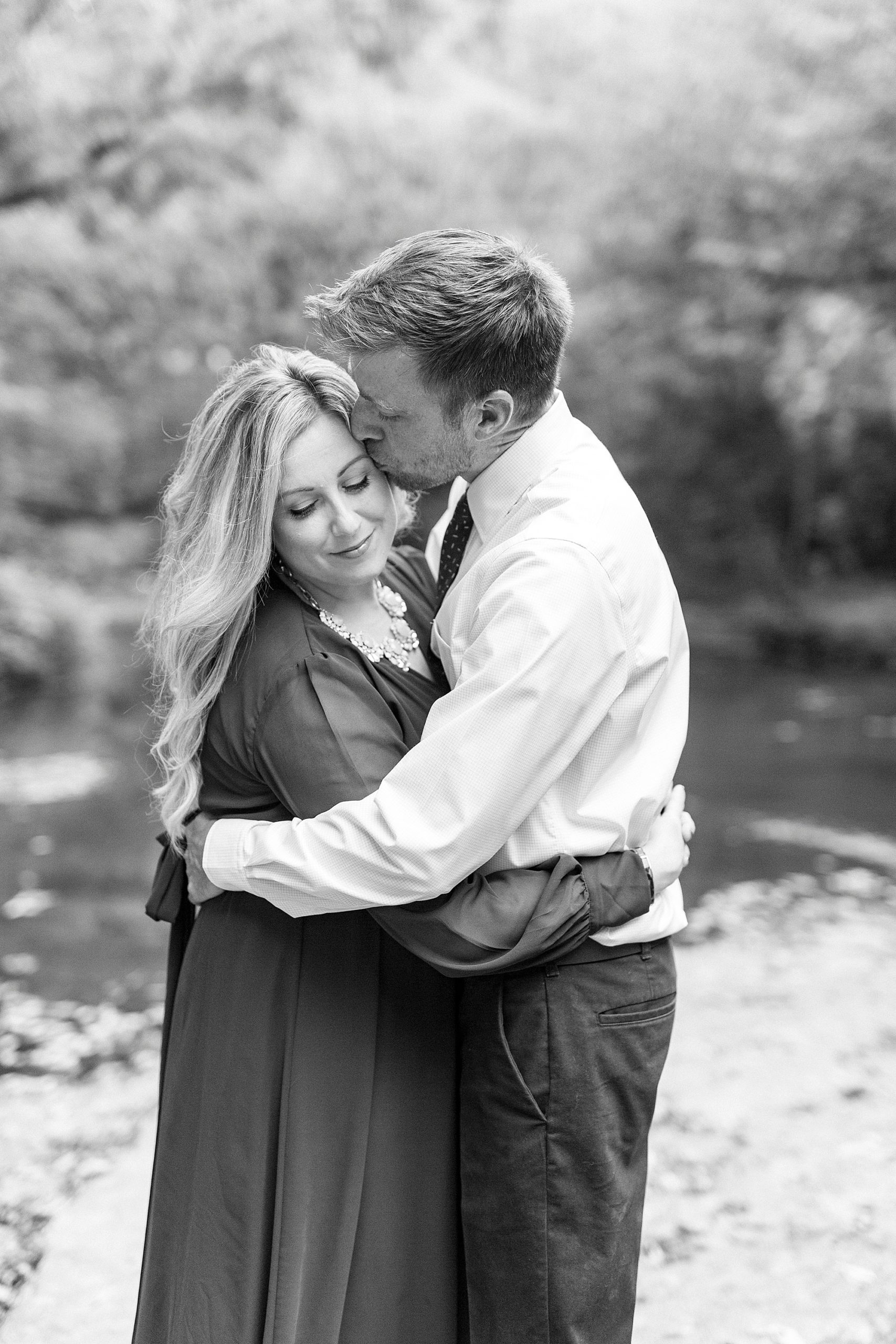 groom kisses bride's forehead during NC engagement session