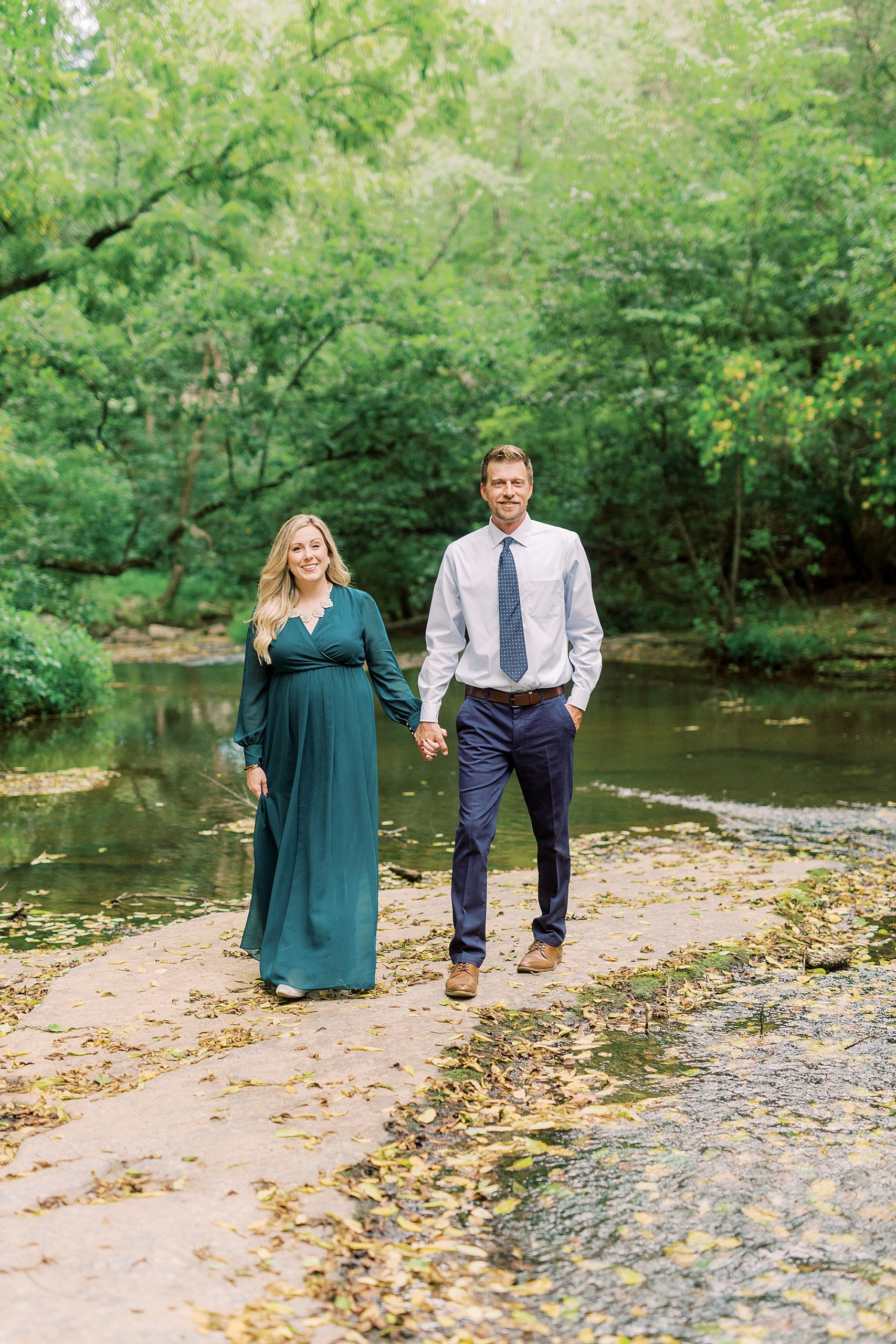 engaged couple walks along riverfront near Vesuvius Vineyards