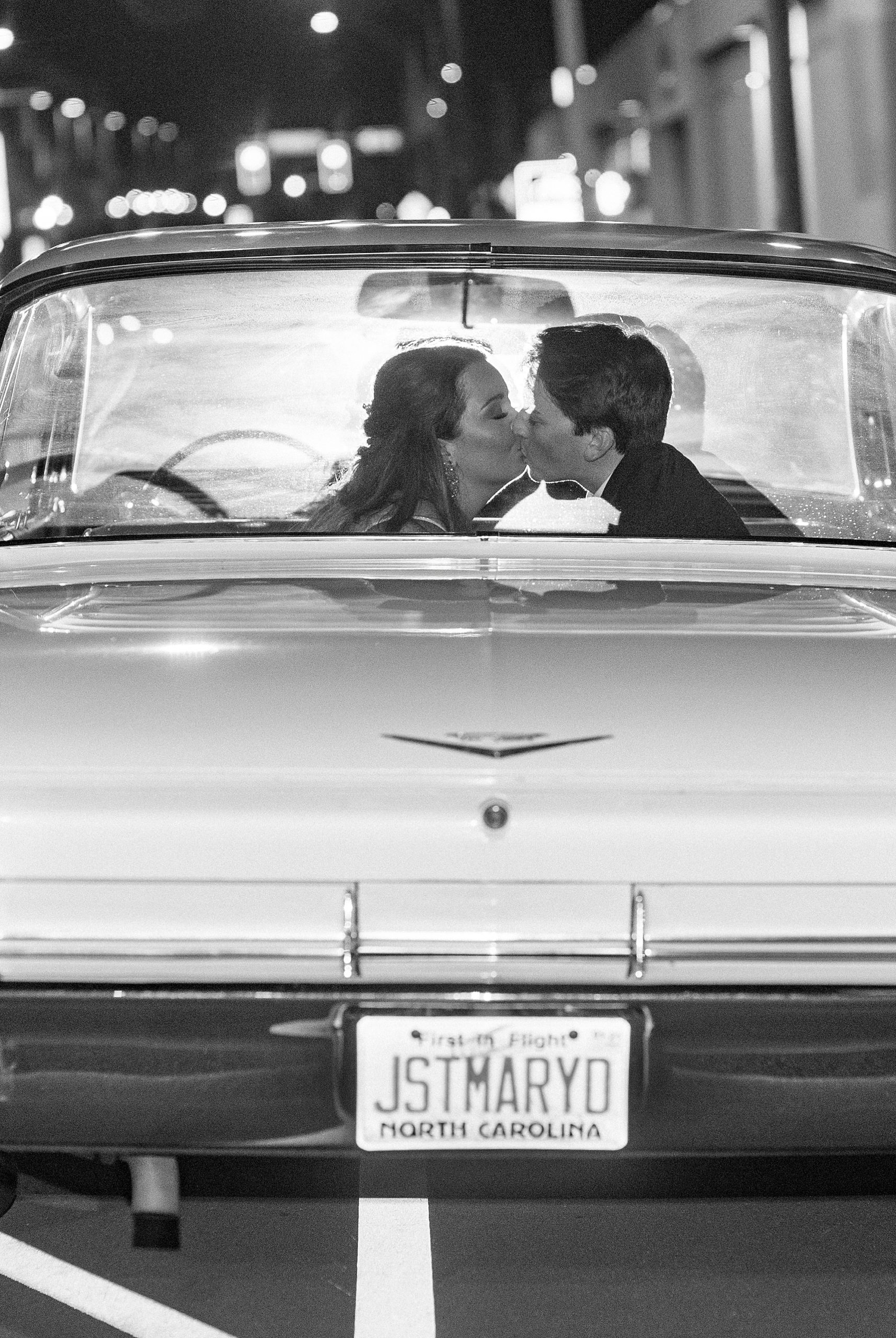 newlyweds kiss in classic car