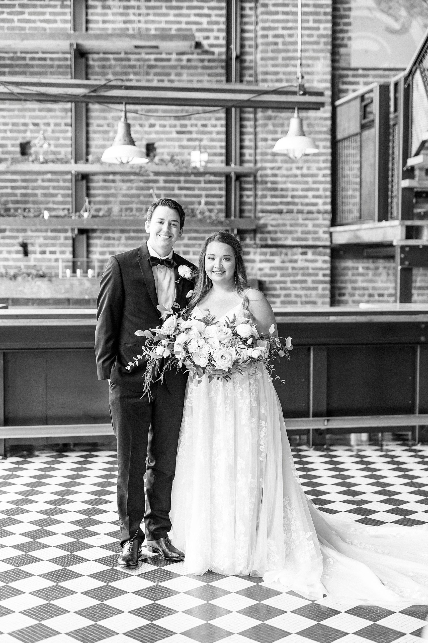 newlyweds hug during portraits in the Cadillac Service Garage