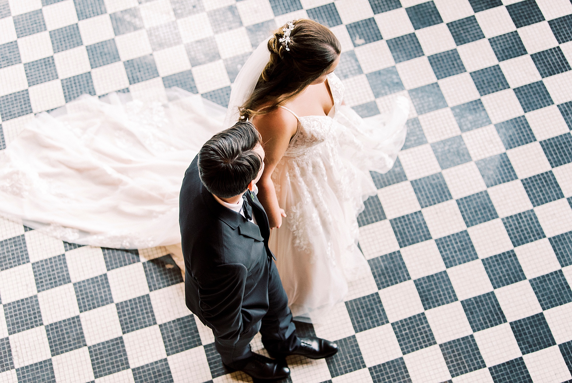 newlywed walk on checkered floor at Cadillac Service Garage