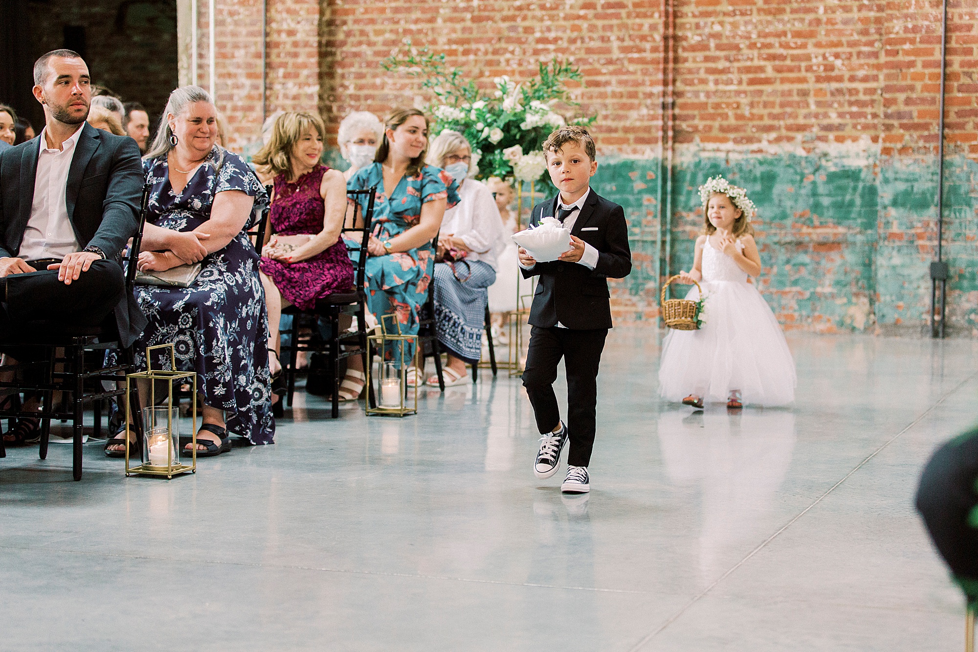 ring bearer and flower girl walk down aisle in Greensboro NC