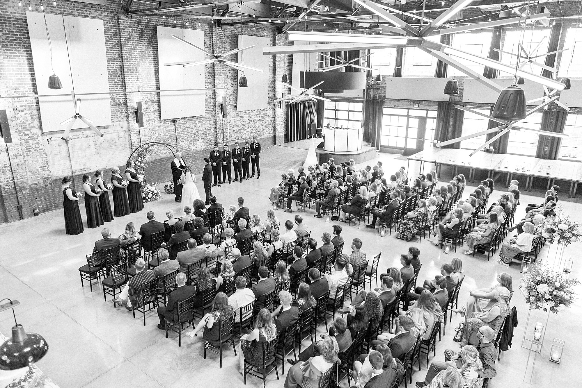 Cadillac Service Garage wedding ceremony with guests seated