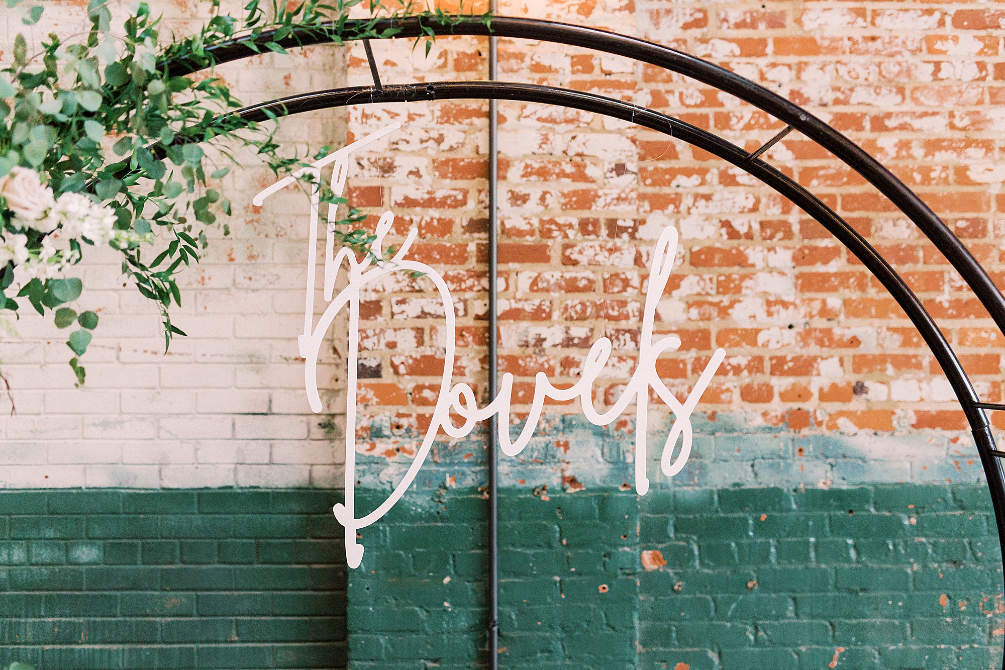 neon sign hangs on brick wall