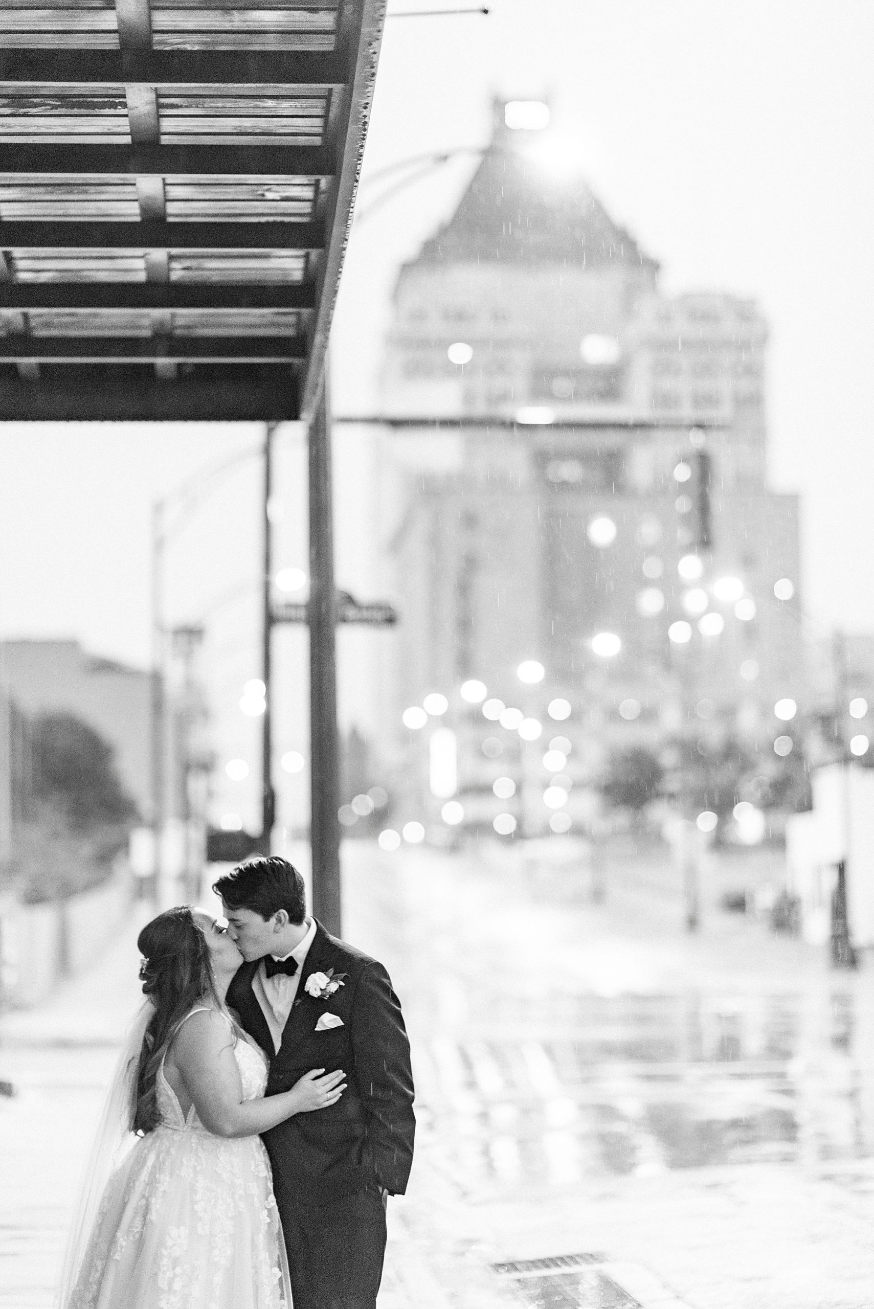 bride and groom kiss on side of road of Greensboro NC