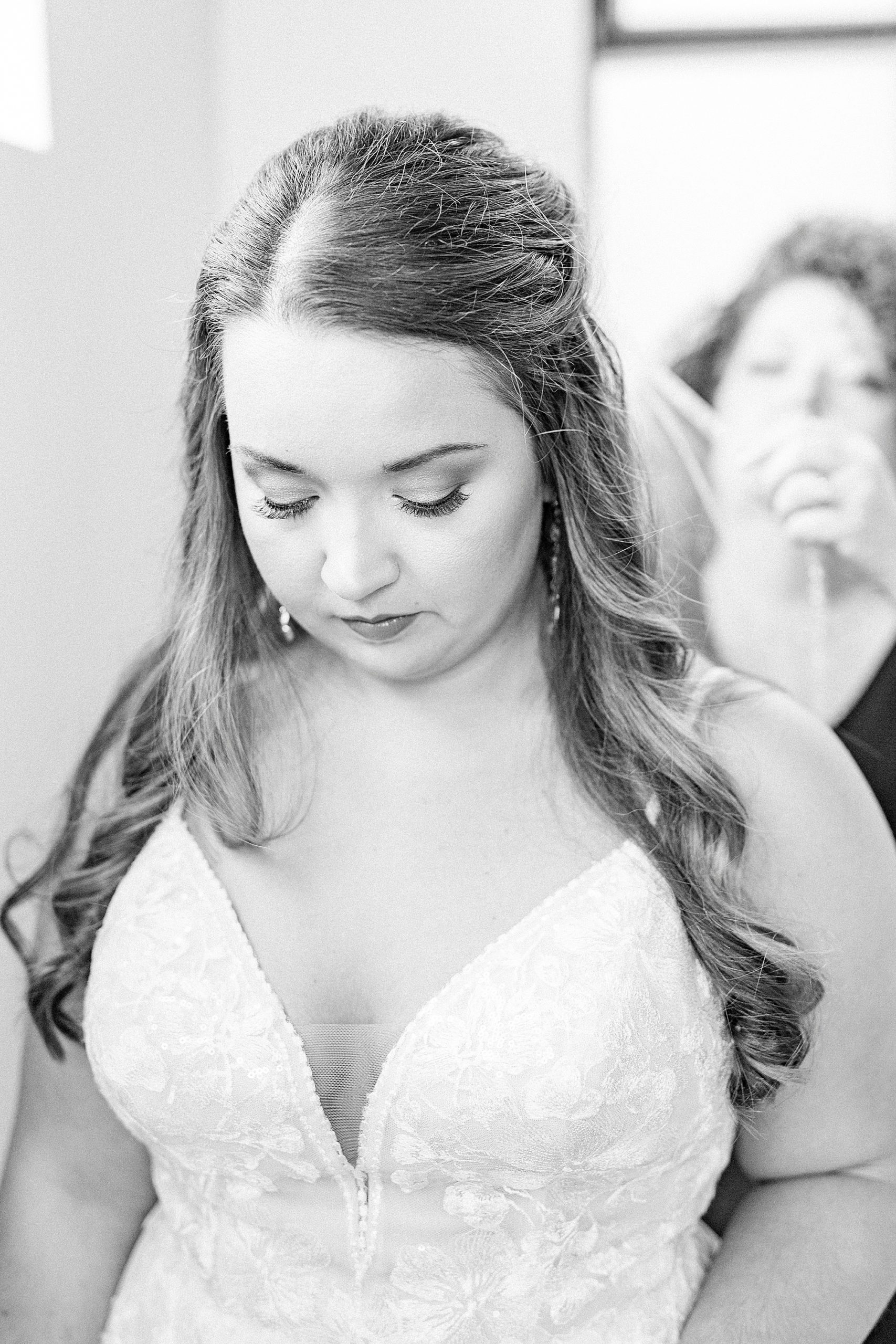 mother helps bride with veil on wedding day in Greensboro NC