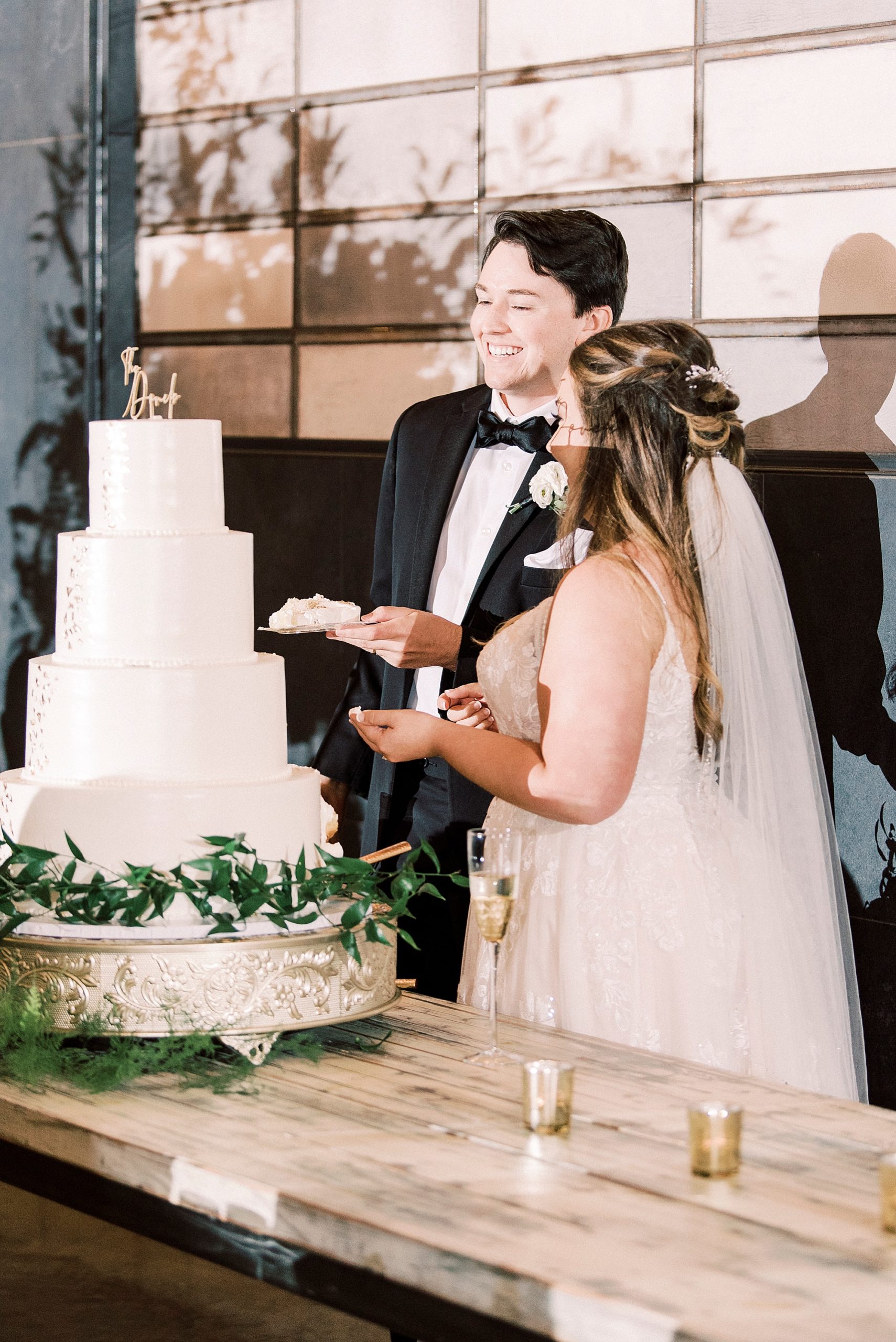 bride and groom cut wedding cake