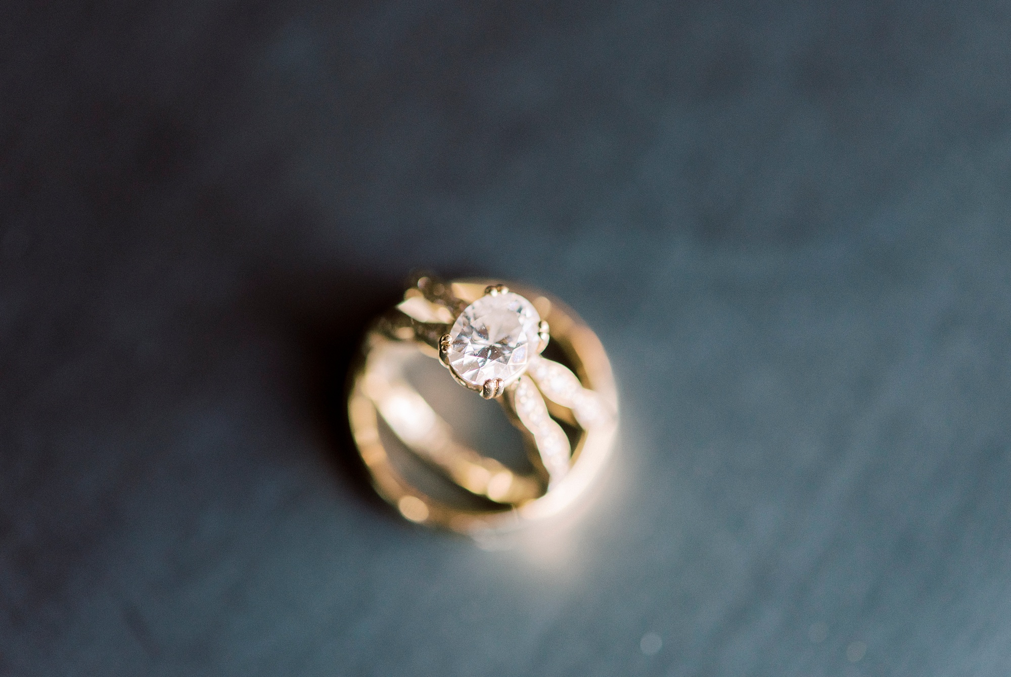 gold bands on dark wood for gold wedding bands for Cadillac Service Garage Wedding