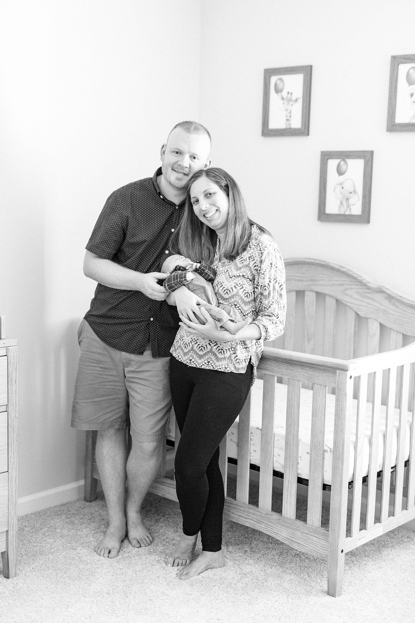 parents hold baby boy during portraits at home