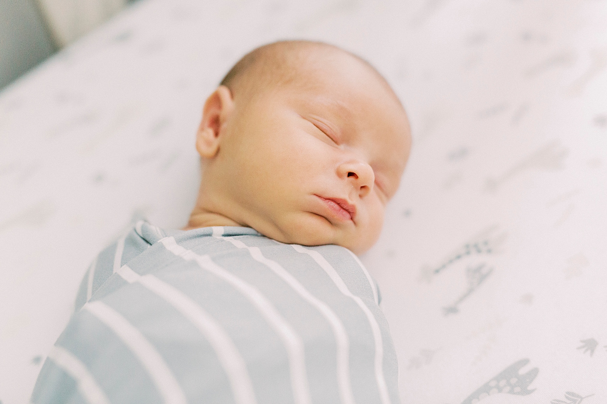 baby sleeps in crib during newborn photos at home