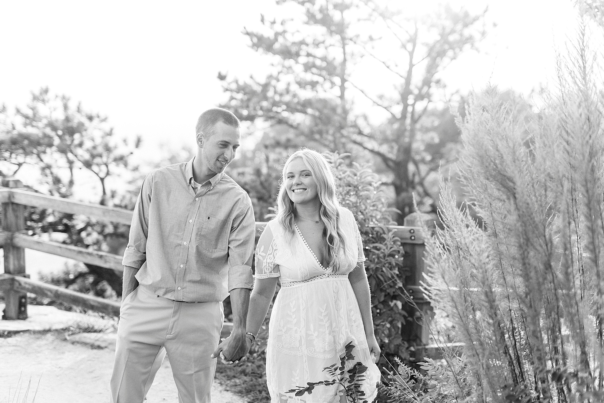 engaged couple walks through overlook on Pilot Mountain