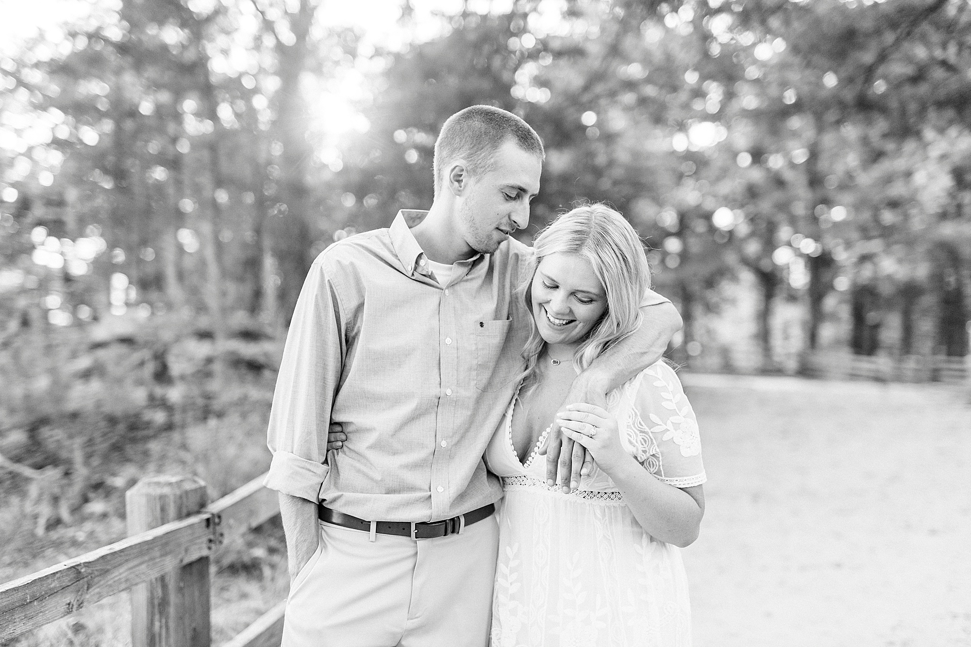 groom looks at bride during Mount Airy engagement session