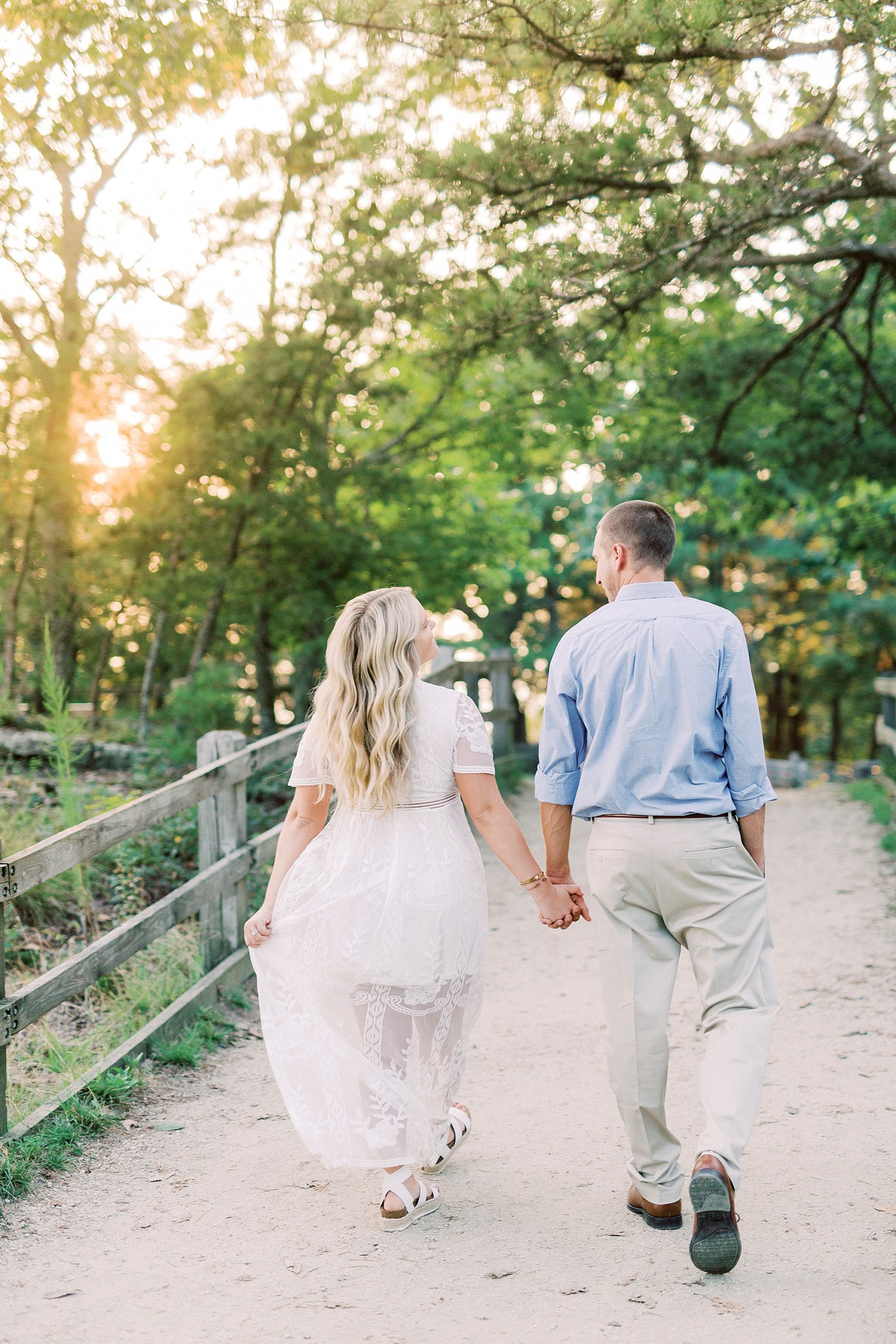 bride and groom hold hands walking on Pilot Mountain