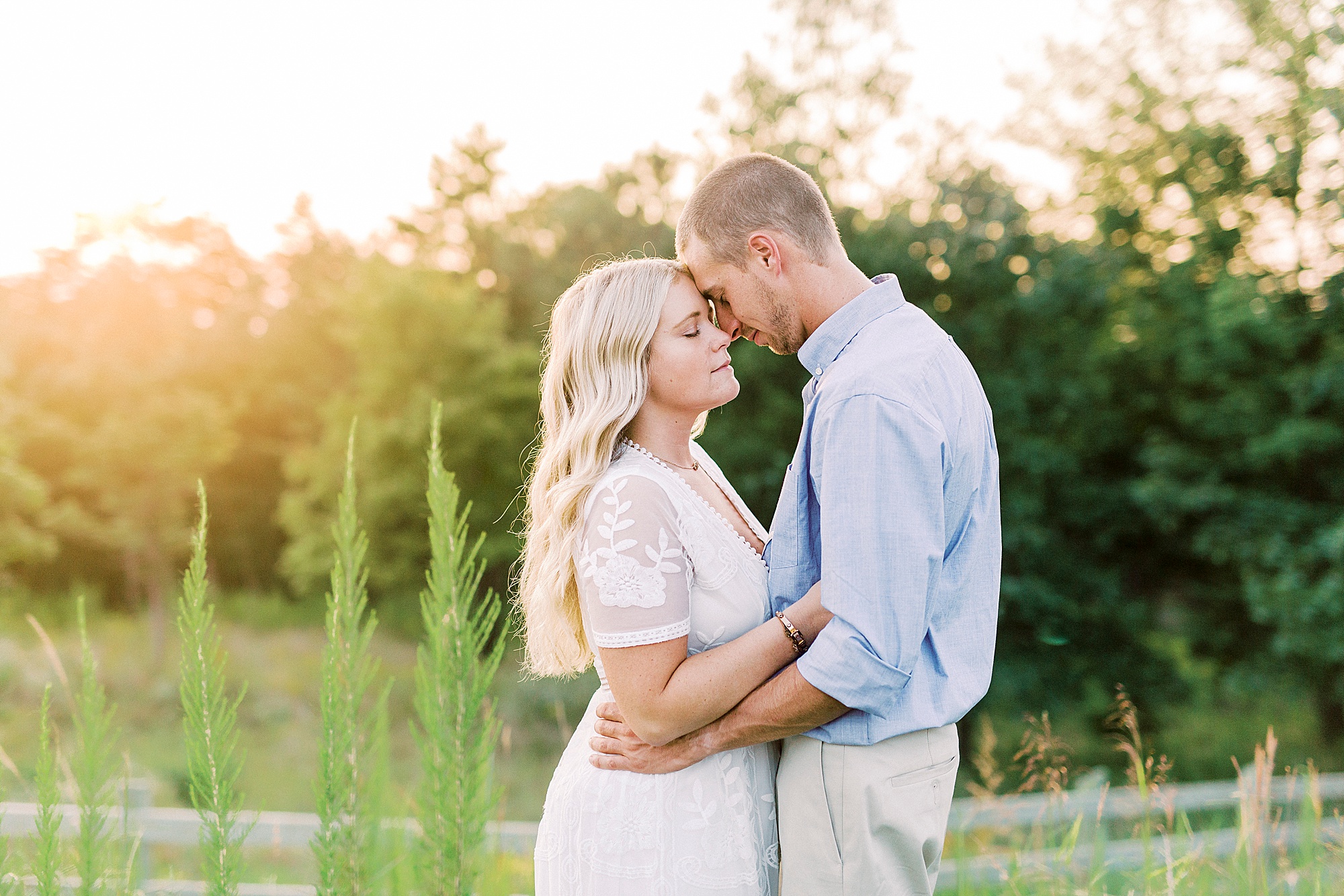 bride and groom stand with foreheads touching