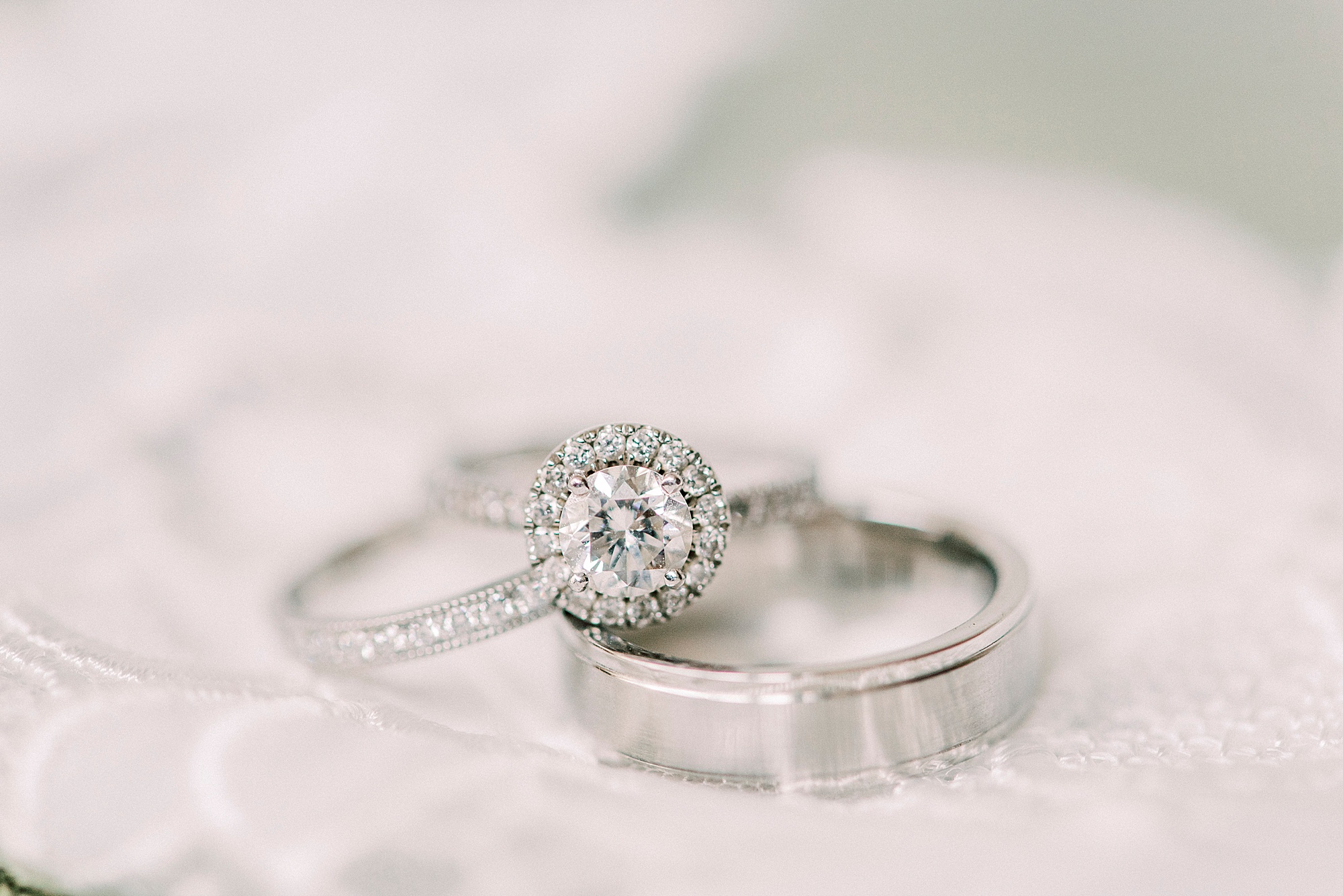 wedding bands lay on veil