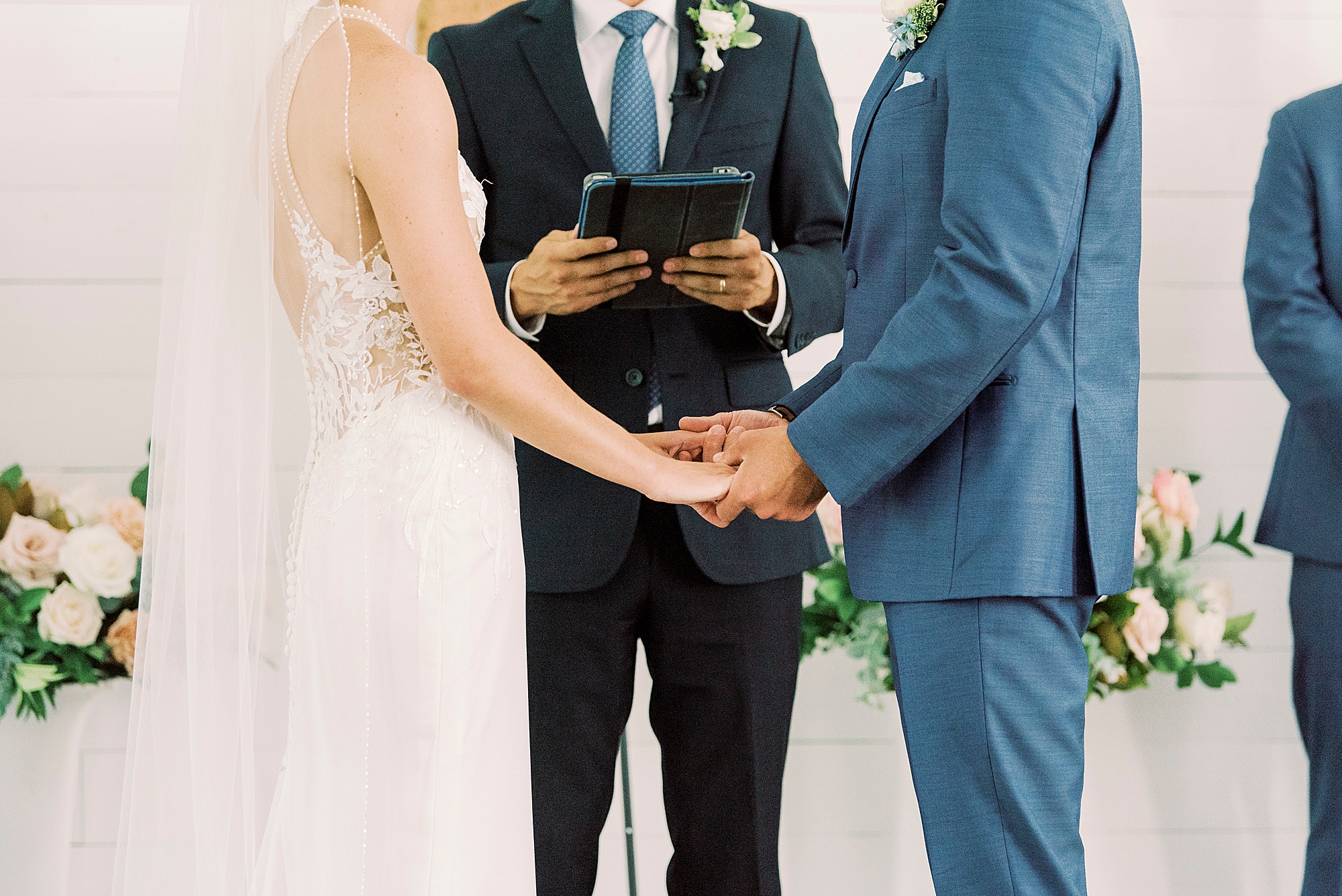 bride and groom hold hands during traditional church wedding in Winston-Salem NC