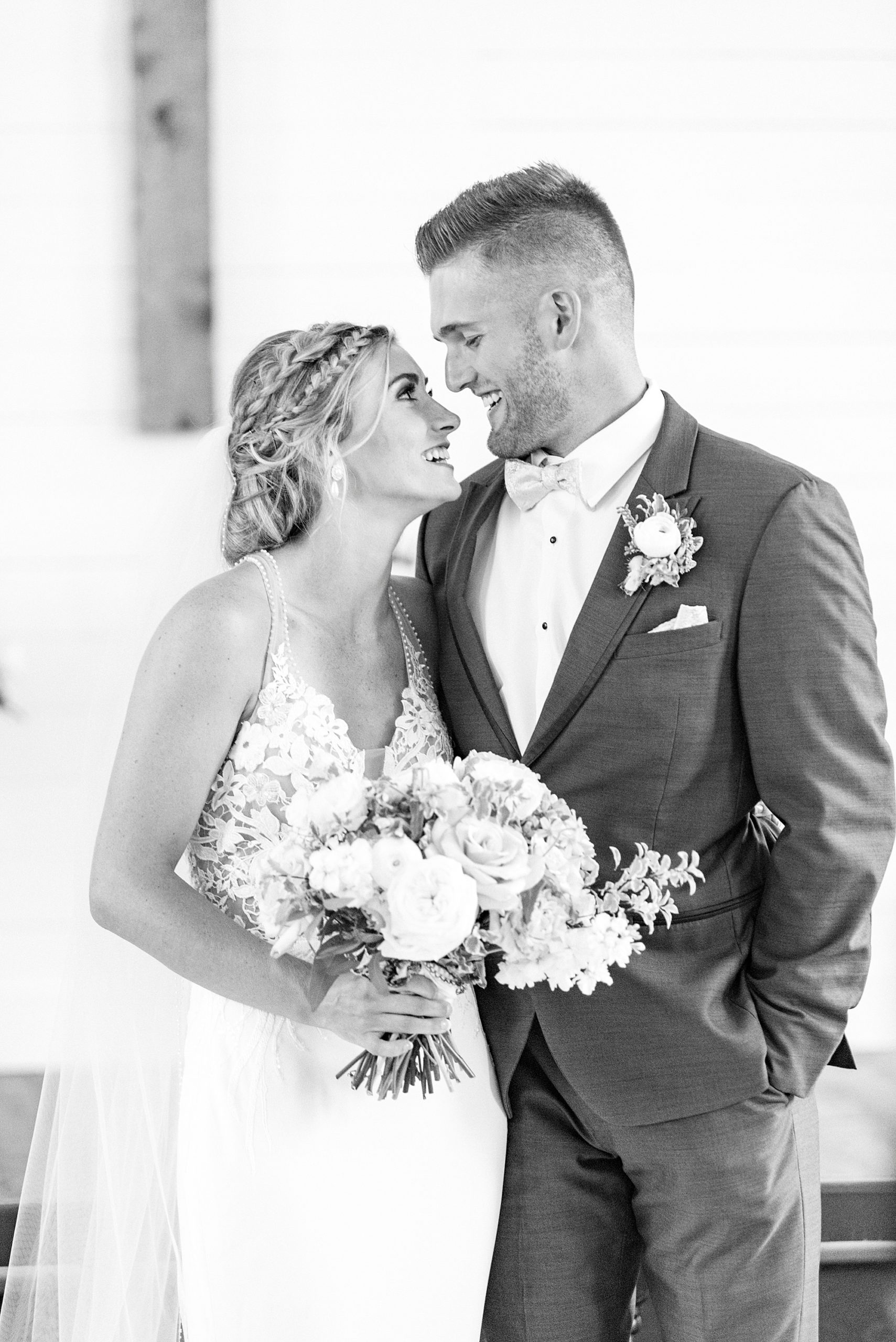 newlyweds pose together during portraits in white church