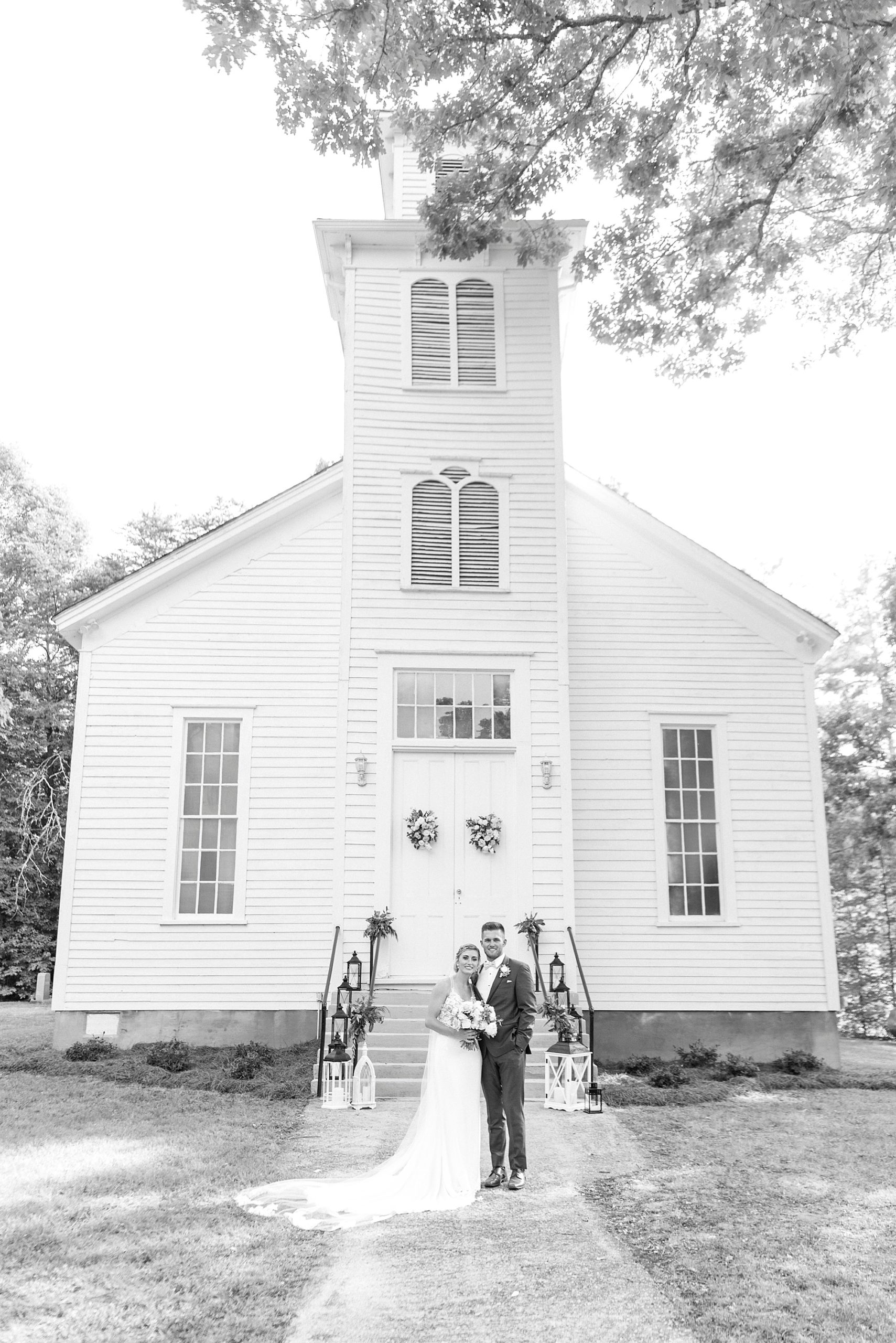 bride and groom pose outside Winston-Salem NC church