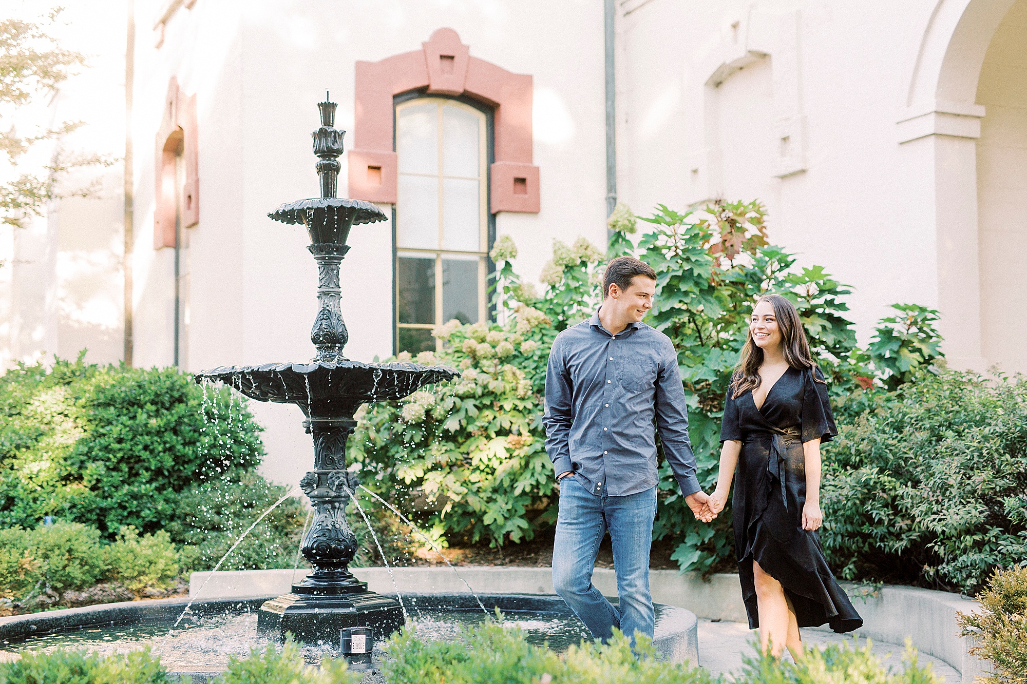 engaged couple walks around fountain in Downtown Concord