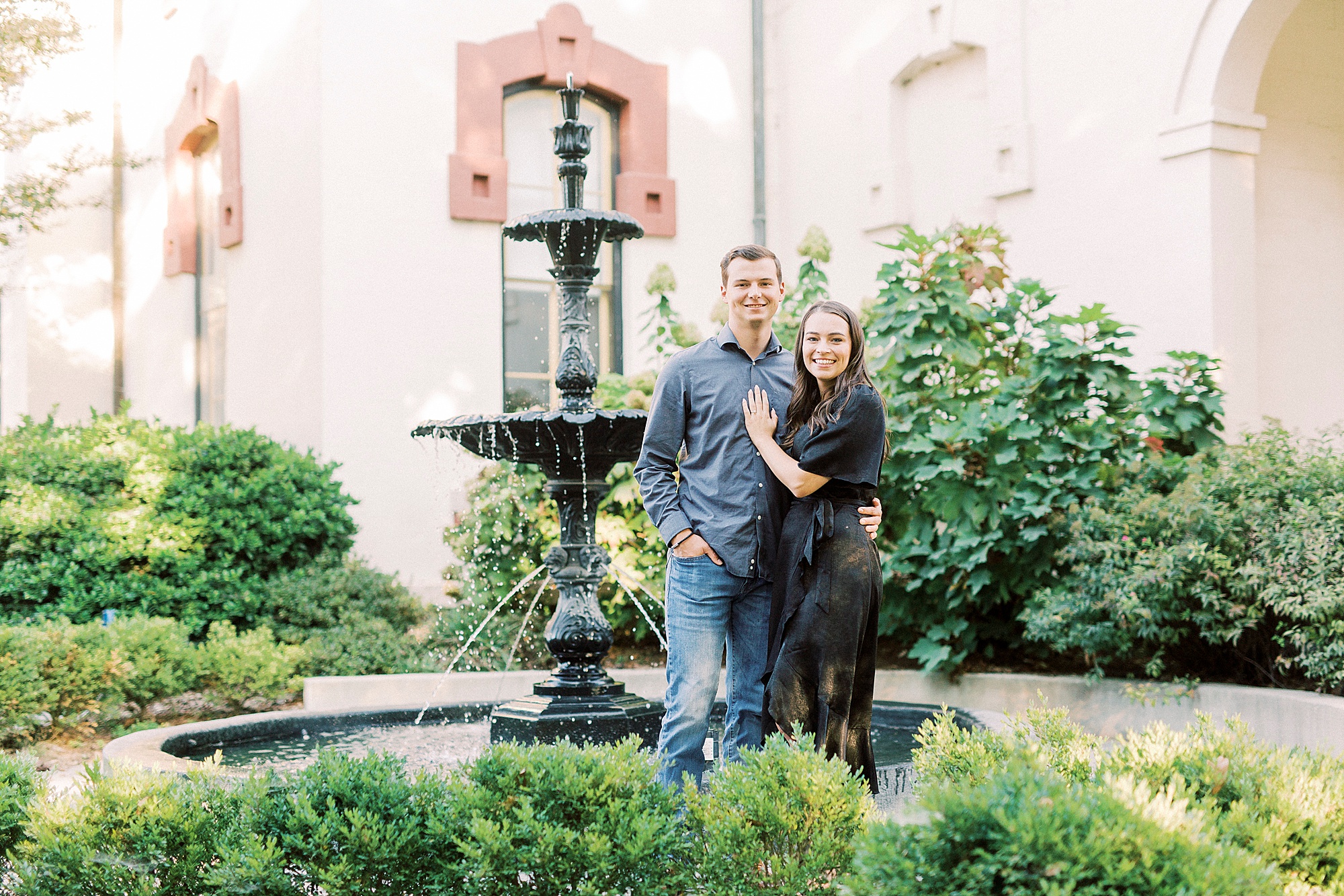 bride and groom hug by fountain NC