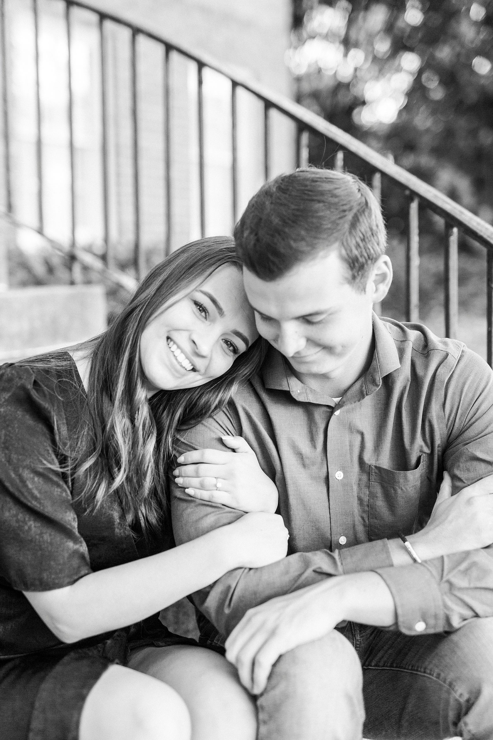 bride leans on groom's arm during Downtown Concord engagement session