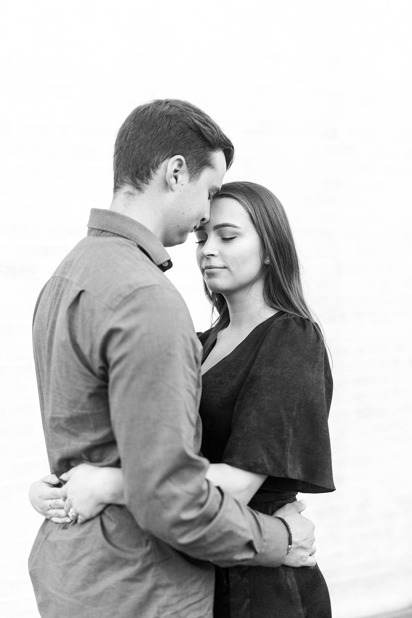 groom touches foreheads with bride during Downtown Concord engagement session