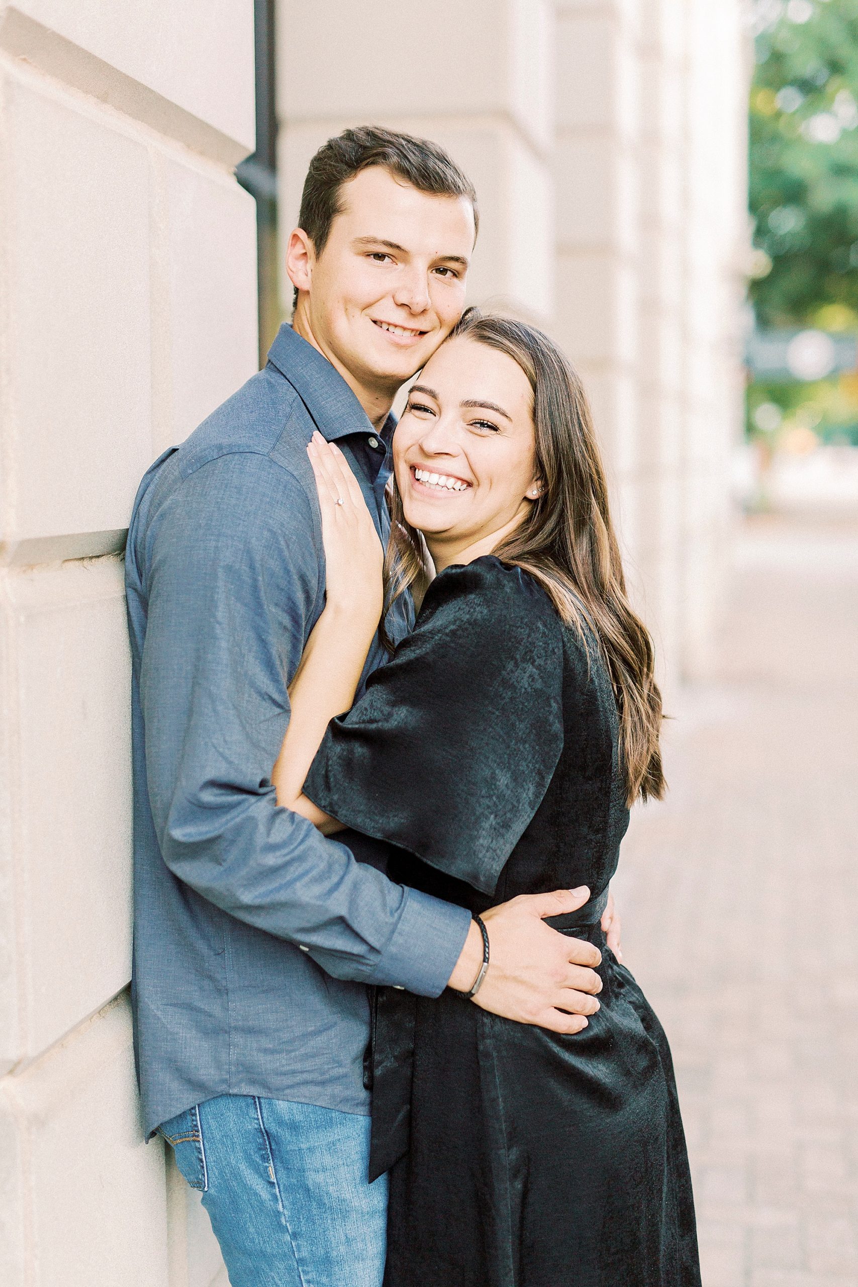 bride and groom lean against wall in Downtown Concord