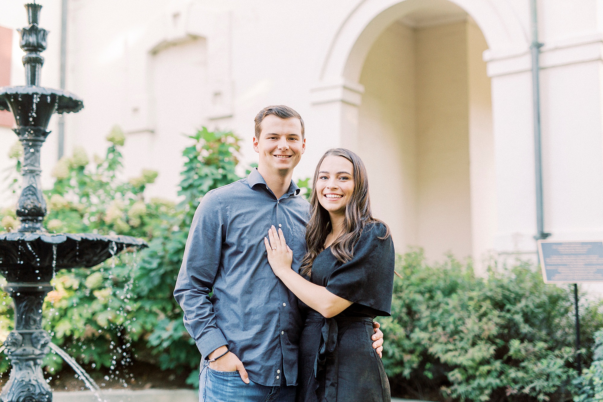 engaged couple poses in gardens in Downtown Concord