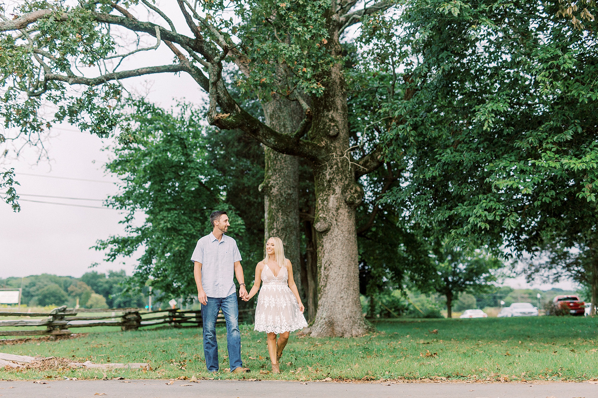 bride and groom hold hands walking through Hodges Family Farm
