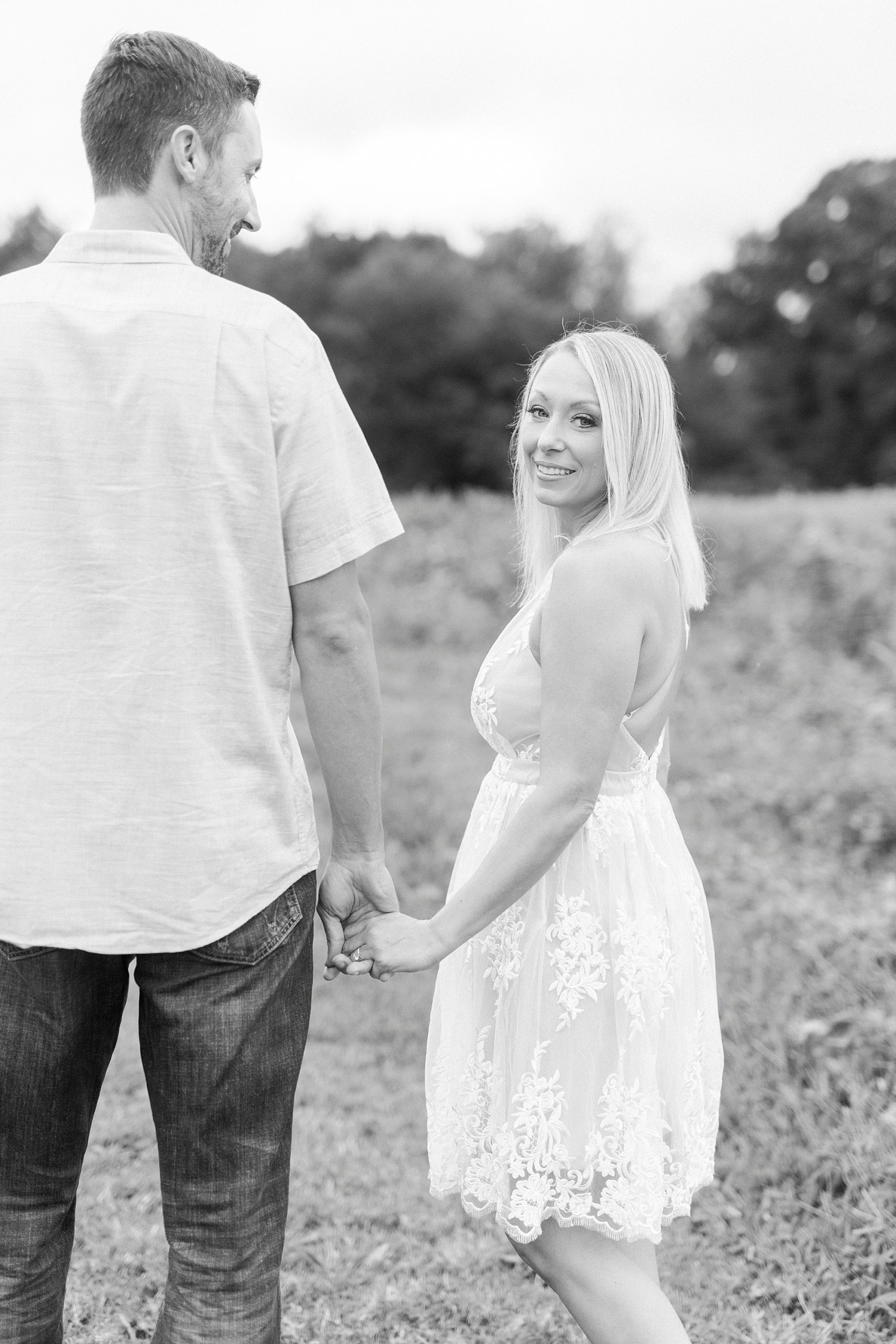 bride and groom hold hands walking through Hodges Family Farm