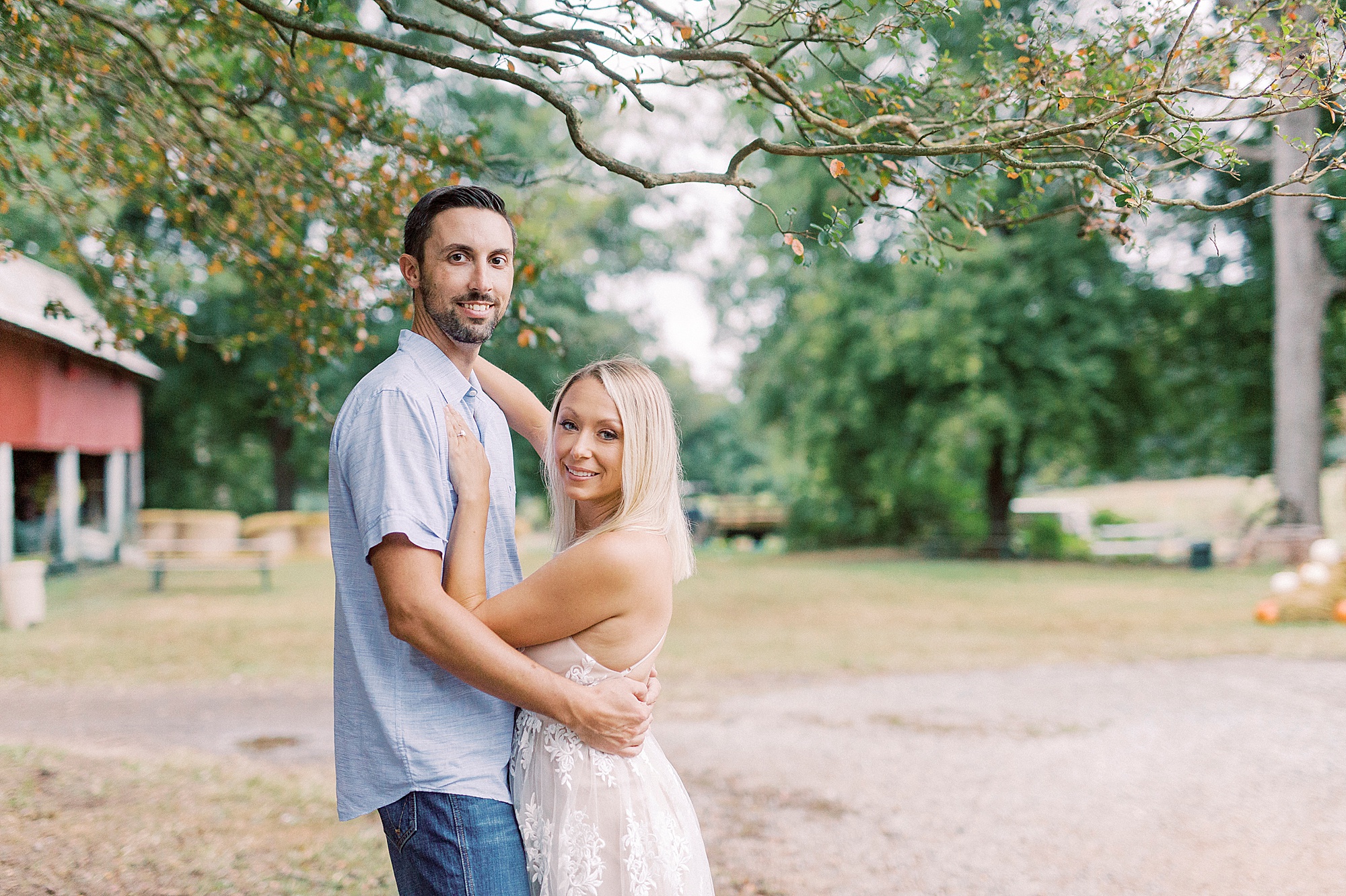 couple hugs by pathway at Hodges Family Farm