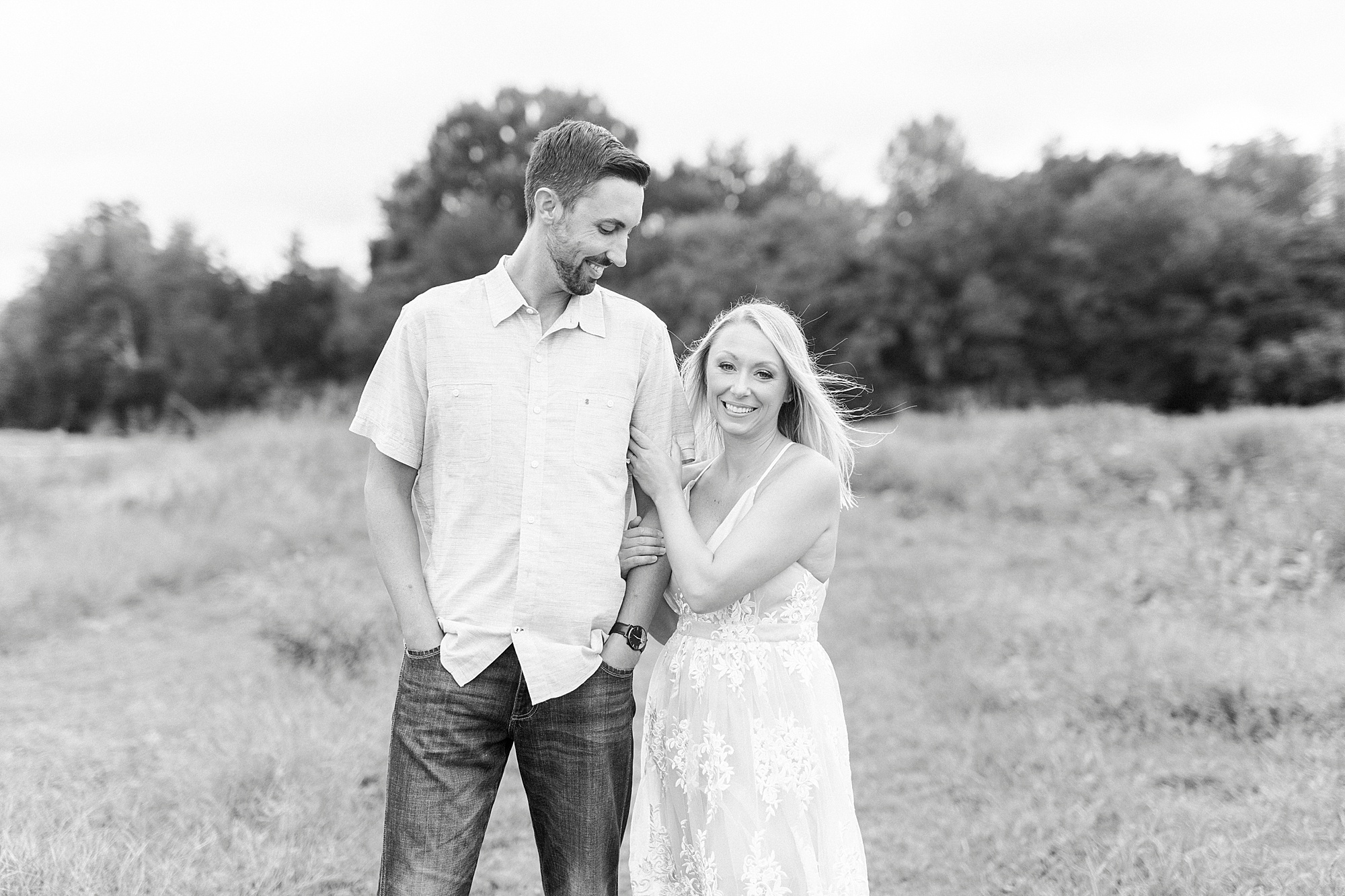 bride holds onto groom's shoulder during Hodges Family Farm engagement session