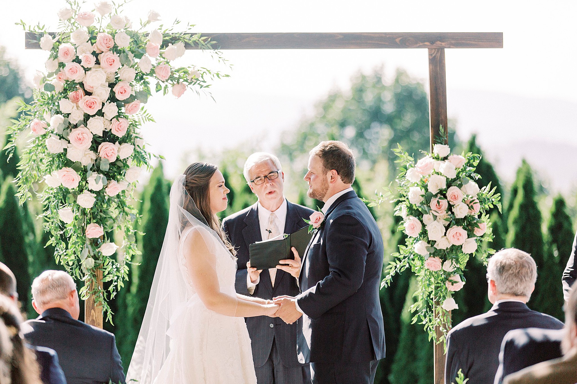 newlyweds exchange during The Inn at Crestwood wedding ceremony