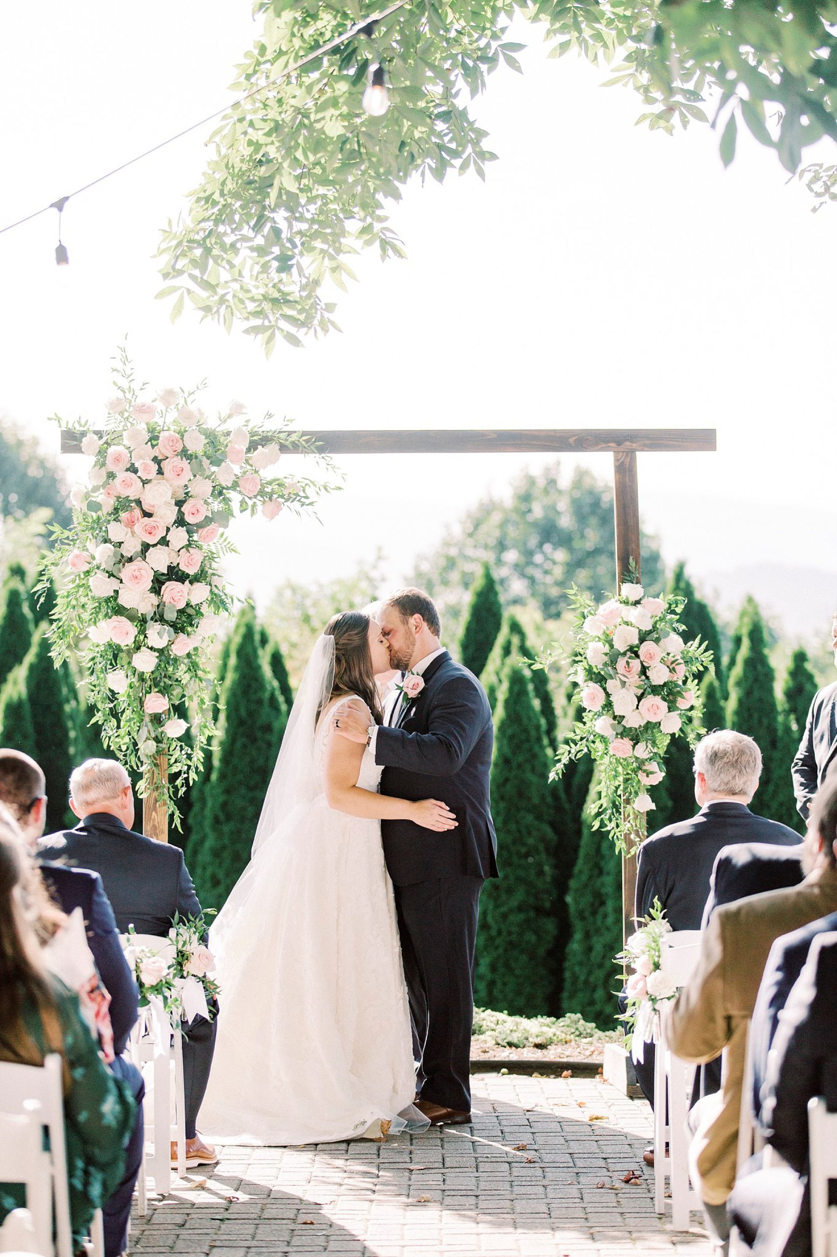 bride and groom kiss during The Inn at Crestwood wedding ceremony
