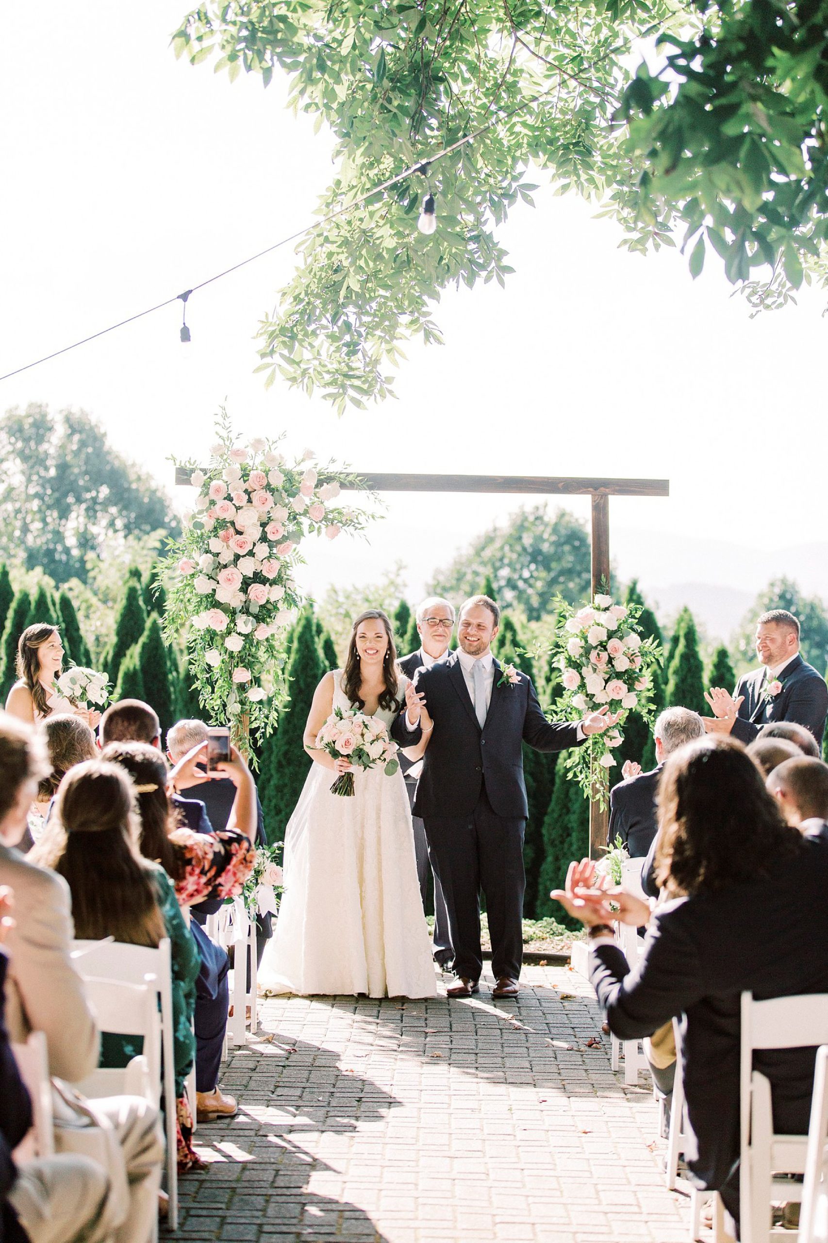 newlyweds walk up aisle after wedding ceremony