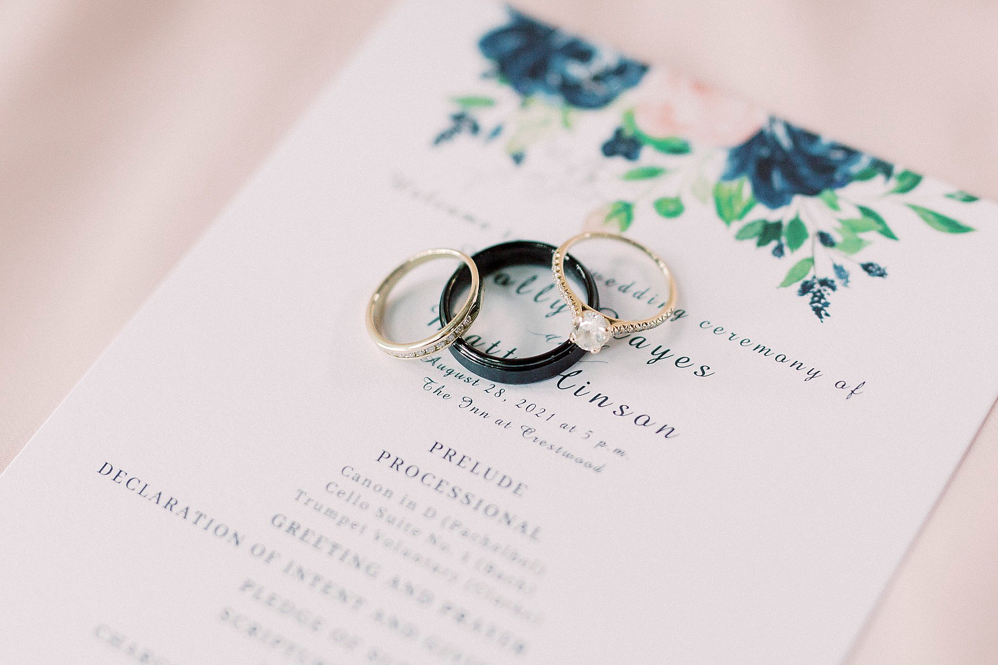 wedding rings lay on custom invitation for summer wedding